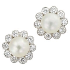 A pair of natural pearl and diamond cluster earrings