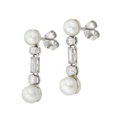 A pair of natural pearl and diamond drop earrings