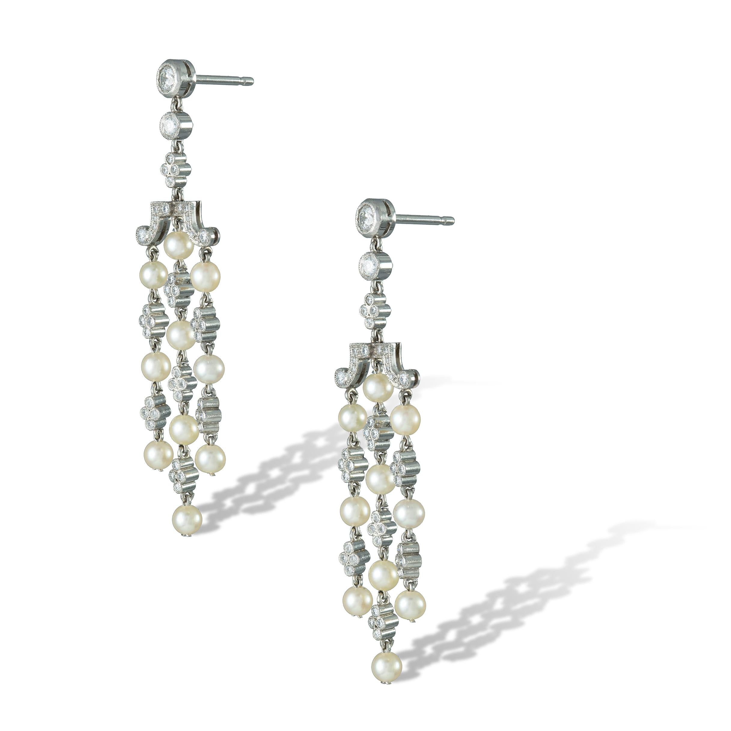 A pair of natural pearl and diamond tassel drop earrings, made by Bentley & Skinner, each earring consisting of three drops embellished with ten natural pearls with a quatrefoil diamond cluster between each pearl, accompanied by GCS report stating