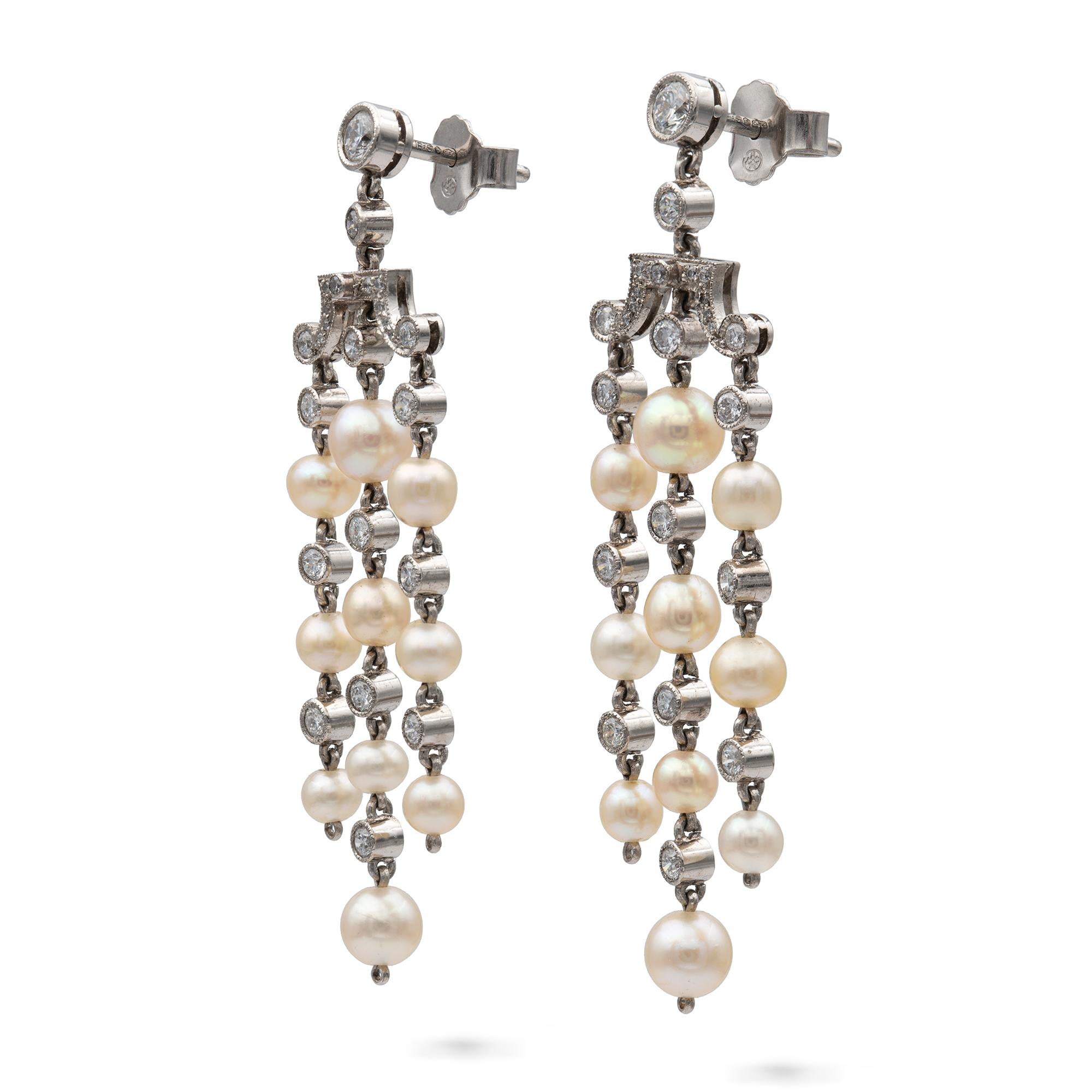 A pair of natural pearl and diamond tassel drop earrings, each earring comprising three drop tassels of ten natural pearls, accompanied by a Gem & Pearl Laboratory report number 03833, with a single diamond in between each pearl suspended from a