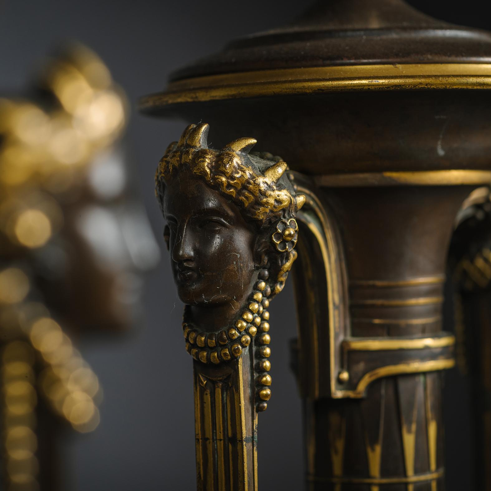 A Pair of Néo-Grec Parcel-Gilt Patinated Bronze Vases Mounted as Lamps, Cast by Ferdinand Barbedienne, from the Model by Henry Cahieux.  

Each vase is finely cast with herm-headed handles flanking a slender elongated neck above a tapering body