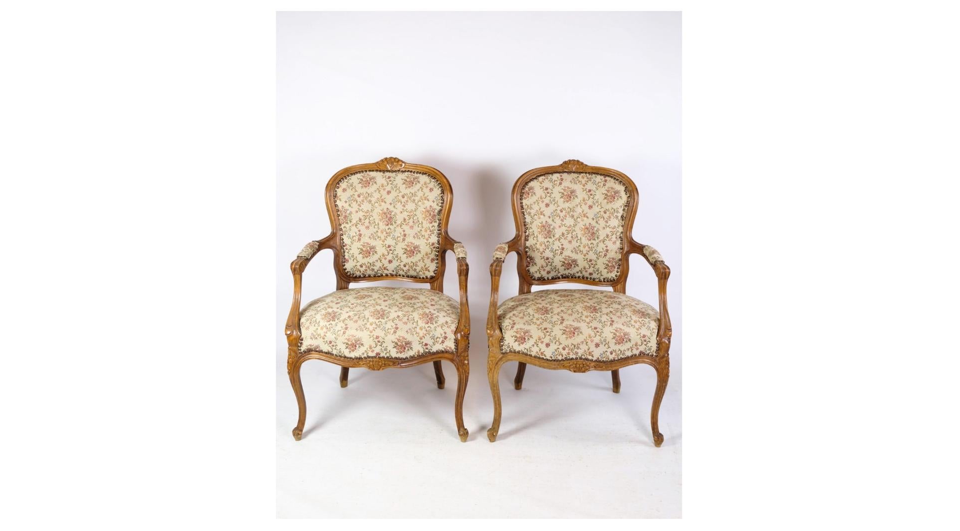 A pair of neo-rococo armchairs with decorative light wood fabric from around the 1930s is a beautiful representation of early 20th century furniture design and aesthetics. These chairs combine elegance and sophistication with a subtle lightness and