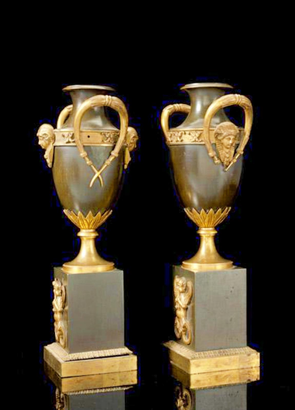 A PAIR OF NEOCLASSICAL GILT AND PATINATED BRONZE CASSOLETTES 19th century
French, 1st quarter of 19th century
H. 30 cm
On rectangular base with applied winged putto heads two Amphora vases, mounted with gilt bronze leaves and sphinx heads.