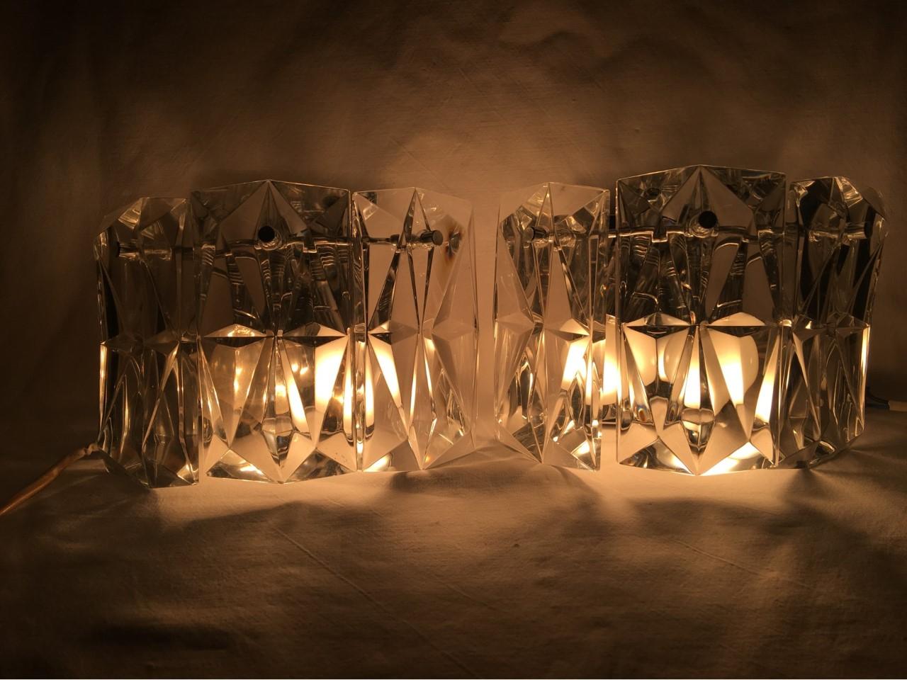 The faceted glass creates a beautiful light effect for this pair of Kinkeldey chrome and glass sconces. Two European E 14 light bulbs with a max of 40 watts each create a superb light for any room. Rewired for US Standards.