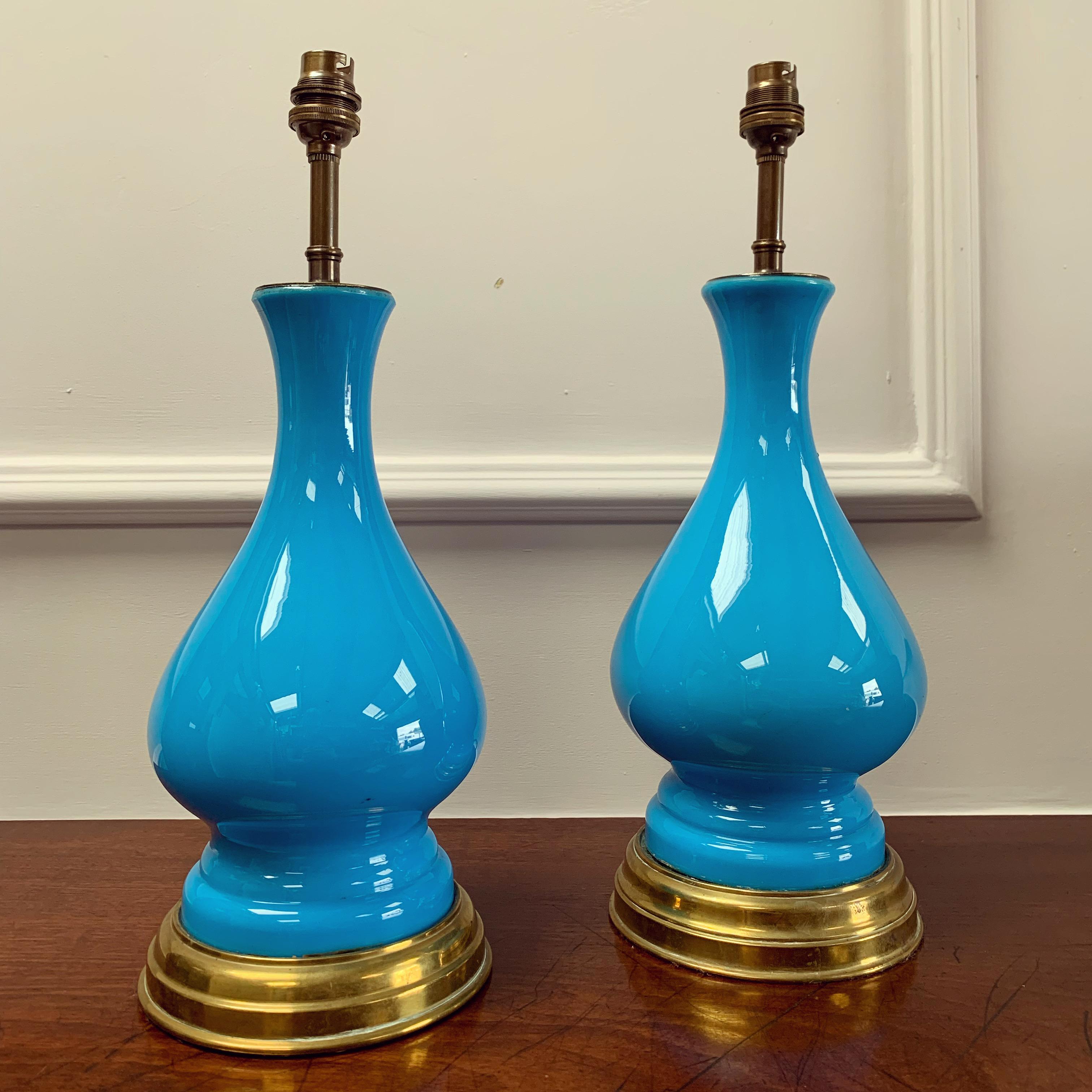 A fine pair of opaline glass vases in sèvres blue with bulbous body, pinched and flared base mounted on stepped brass base, now as lamps. 

Continental, Mid Nineteenth Century 
