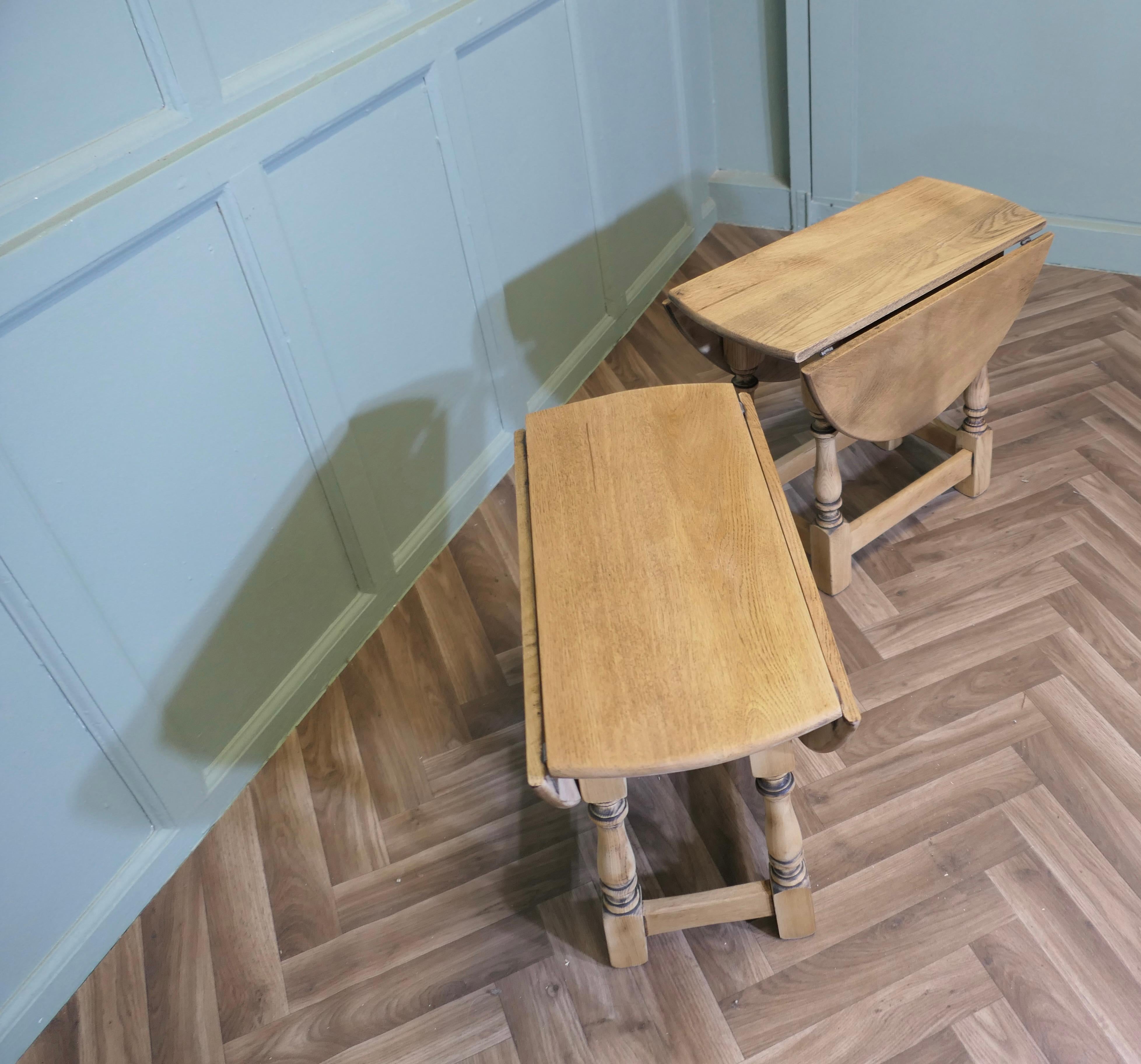 A Pair of Oak Coffee or Side Tables

This is a good pair of bleached Oak side tables which have the added advantage of dropping their leaves to save space, just raise the oak flaps and twist them into position to convert into oval coffee  tables
The