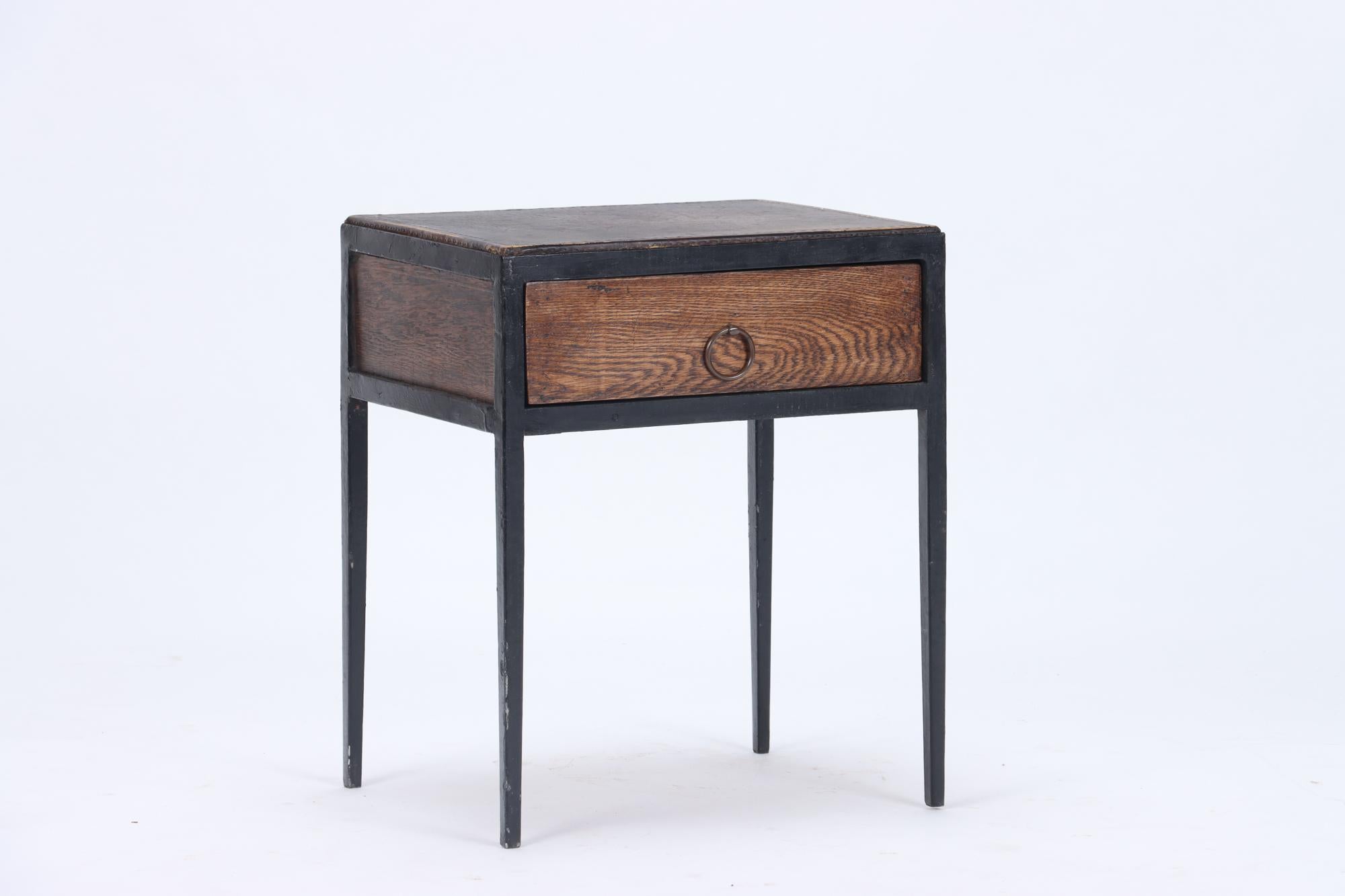 A handsome pair of oak, leather and iron single drawer night stands . Circa 1945.