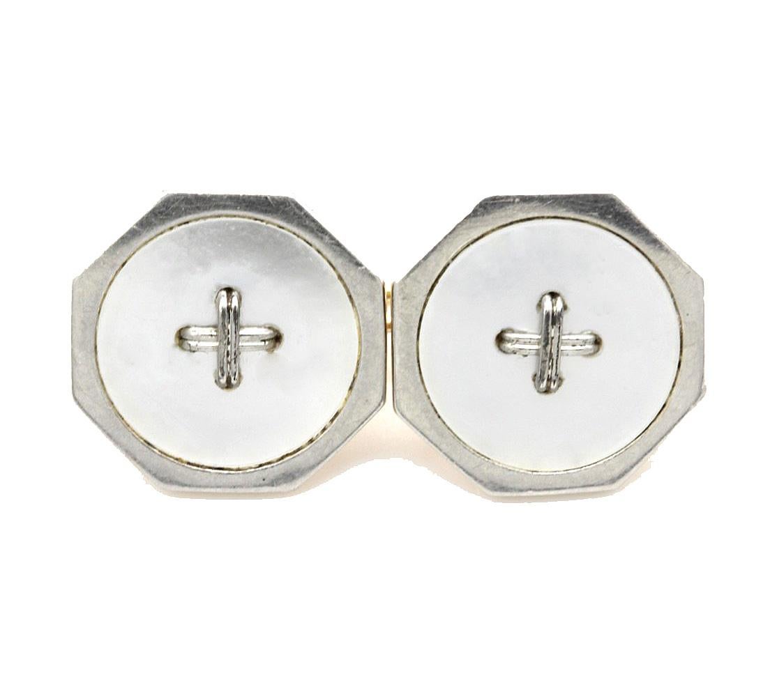 A Pair of Octagonal White & Rose Gold. Mother of Pearl Cufflinks in the Original Velvet Lined Box. 
The octagonal mother of pearl link with a white gold central cross and surround, backed with rose gold and joined by a chain.
Stamped 9ct