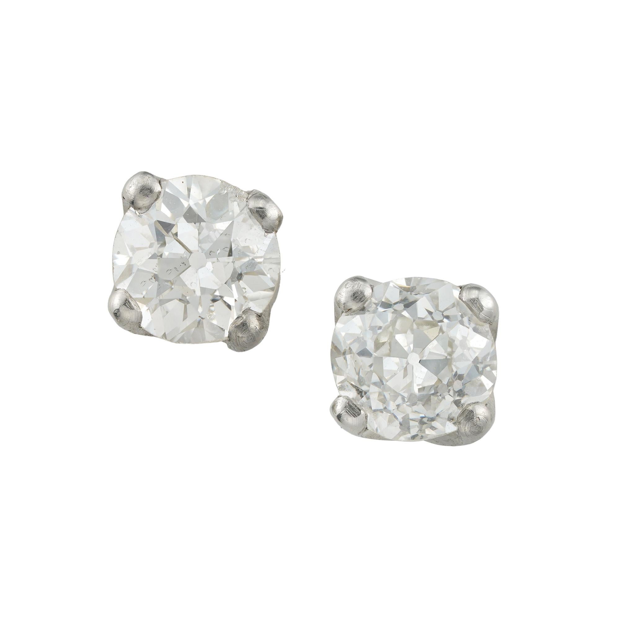 A pair of old-cut diamond stud earrings, the two old European-cut diamonds, the one of weighing 0.63 carats of I colour and VS2 clarity, the other diamond weighing 0.60 carats of K colour and I1 clarity, both accompanied by De Beers grading reports,