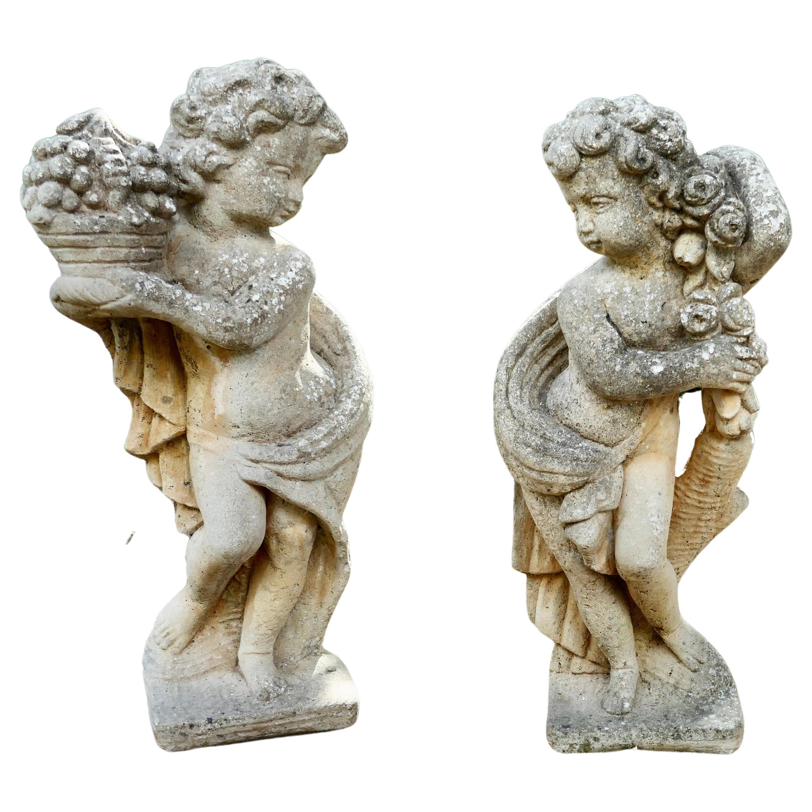 Pair of Old Weathered Classical Flower Children Statues For Sale