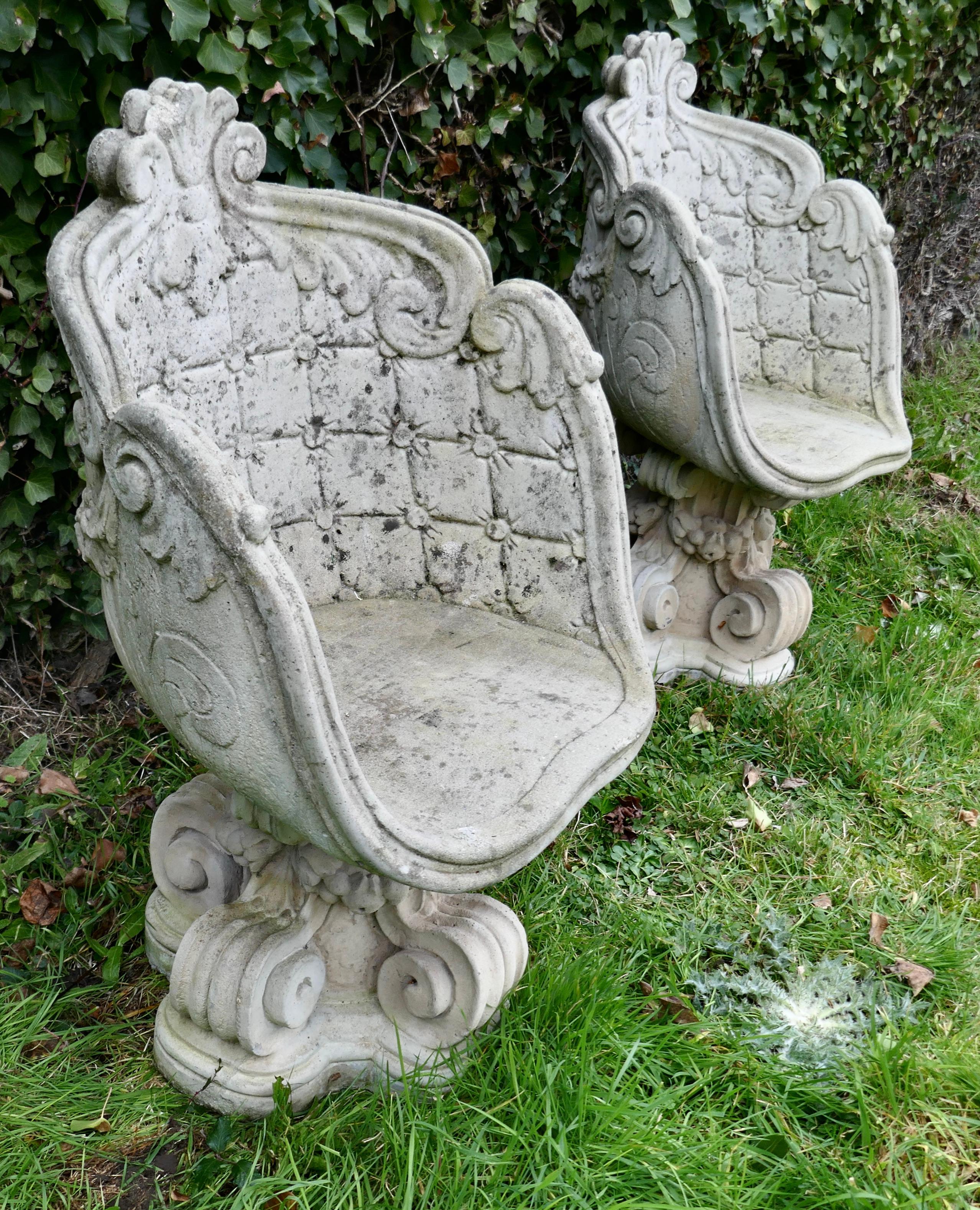 A pair of old weathered stone garden seats 
 
These are an unusual pair delightfully decorated, the base of the seats are in the form of 4 large scrolls forming the central leg, the seats are a tub shaped throne and very comfortable

The pair