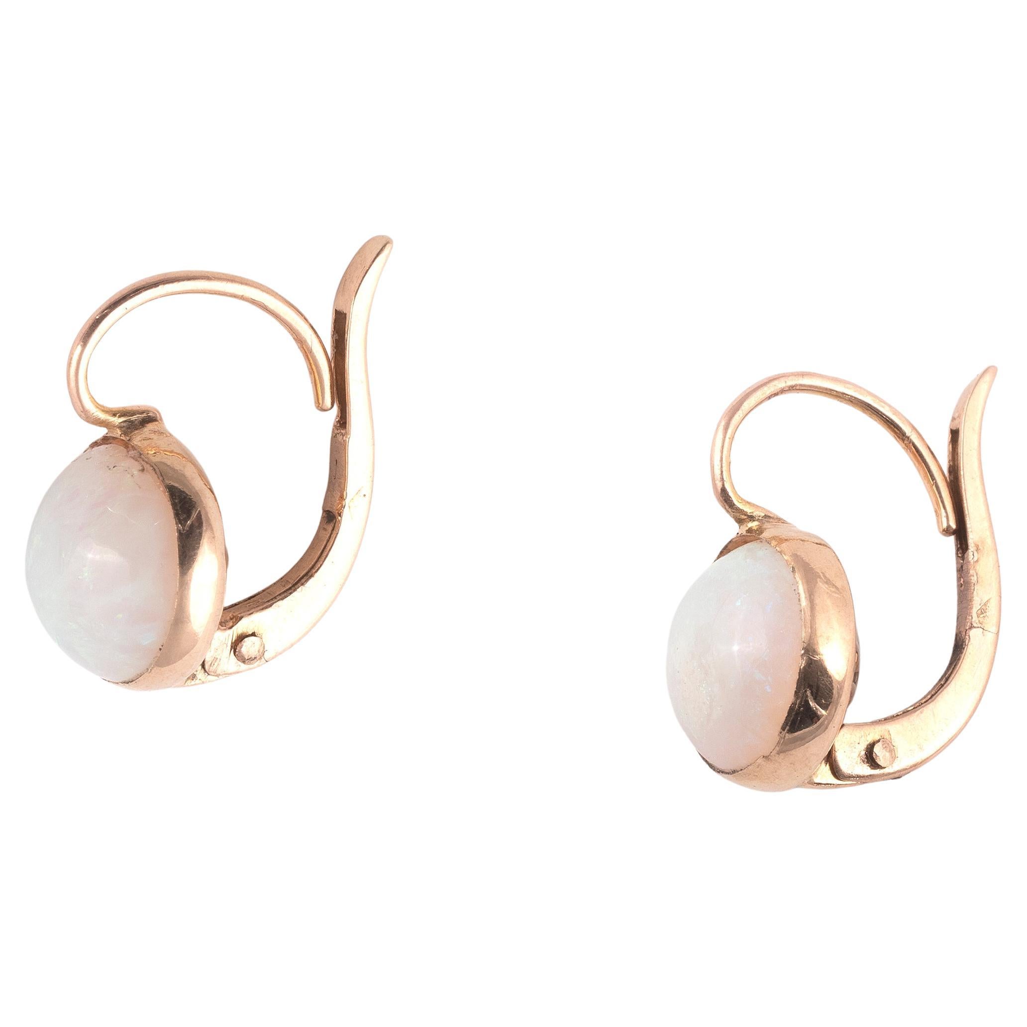 A pair of opal and 18kt yellow gold earrings, the round solid white opal cabochons are claw-set within in yellow gold, 15mm long
Weight: 3.30gr.

Follow on instagram @bernardoantichita