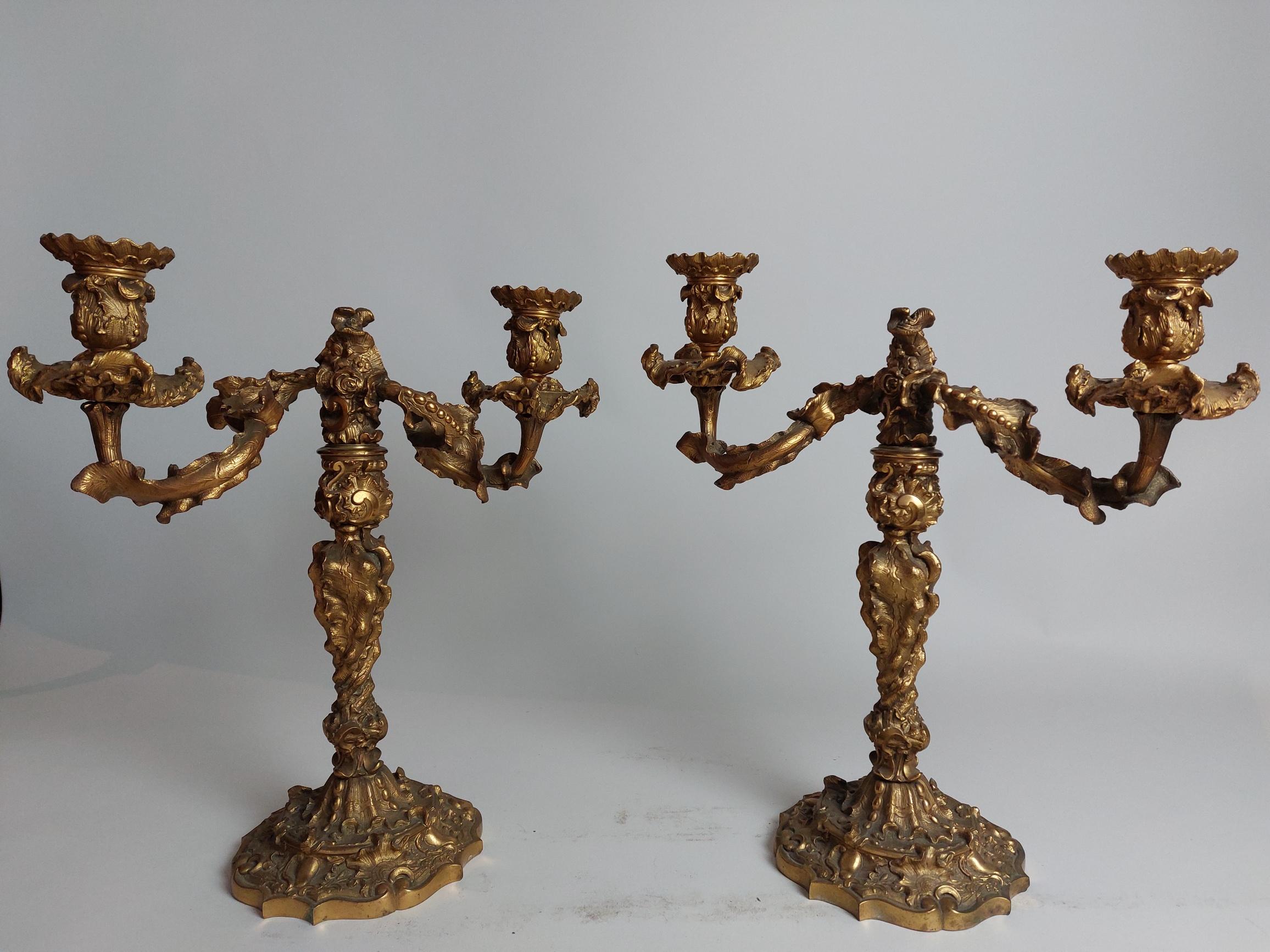 A pair of opulent Regency (1811-1820) ormolu candlestick holders.