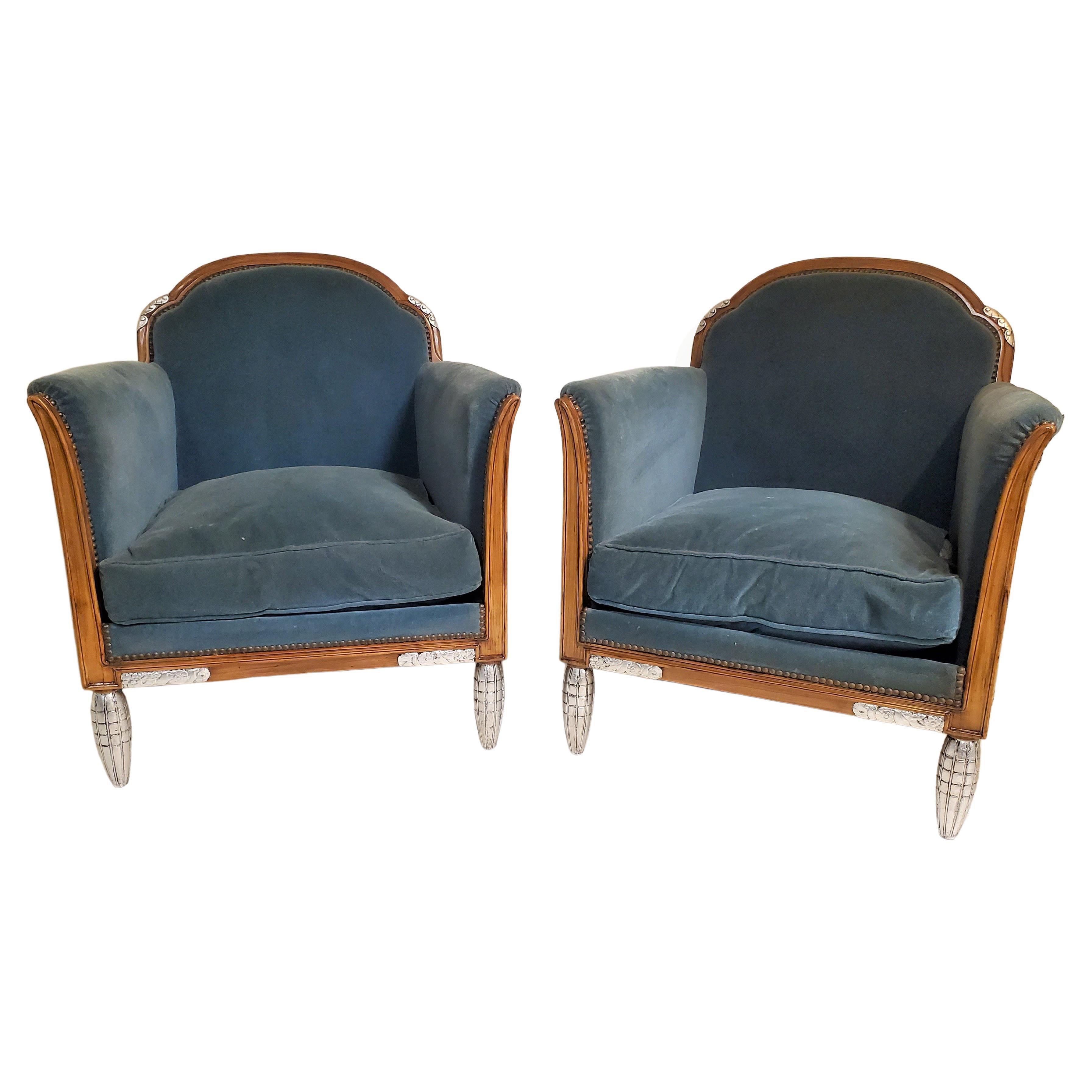 A splendid pair of expansive and comfortable French Art Deco armchairs attributed to Paul Follot (1877-1941) featuring gracefully curved, half-rounded backrests and stylized blade shaped arms that splay open exuding a warm and inviting