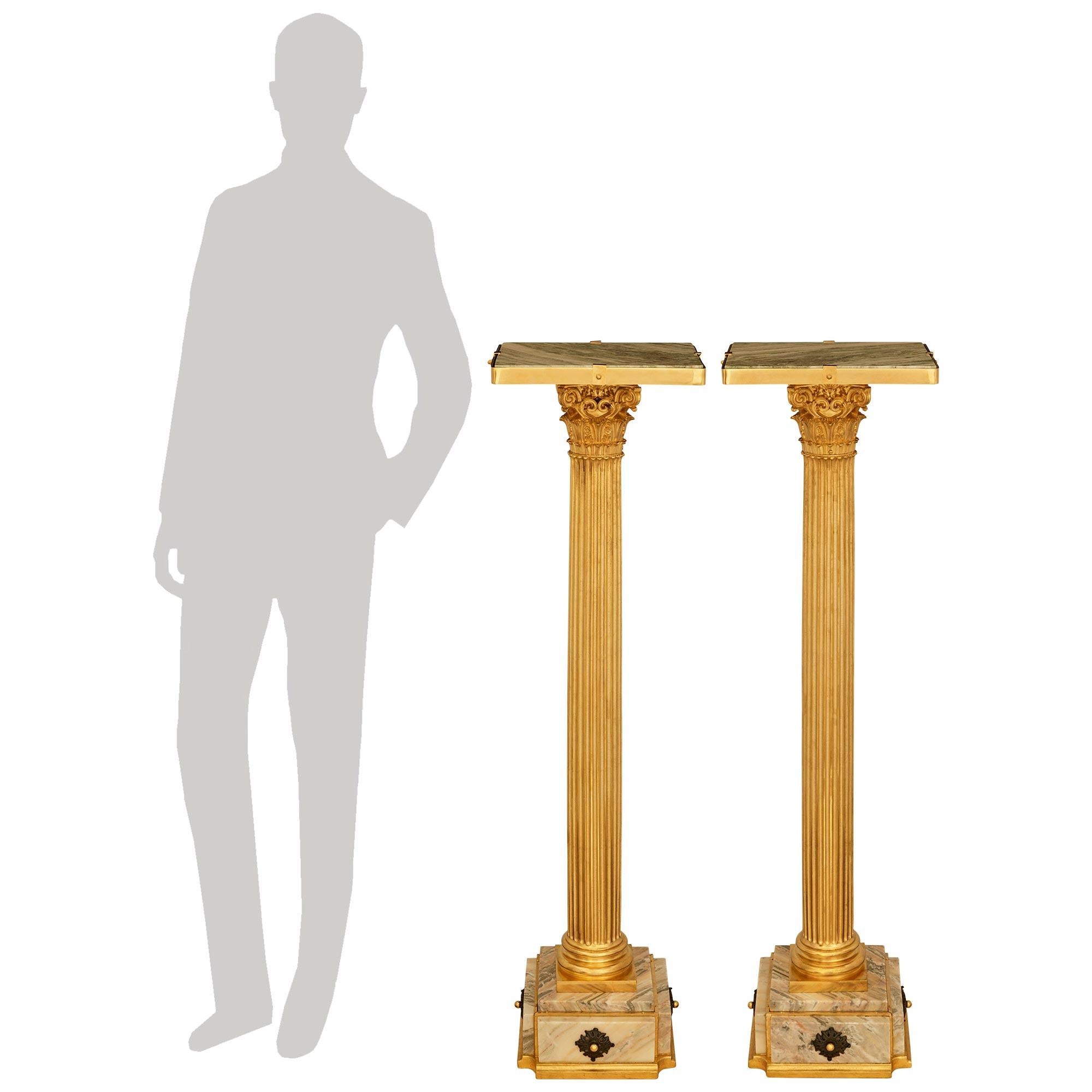 A striking and most decorative pair of Continental 19th century Neo-Classical st. Ormolu, patinated Bronze and Rose Saint Pons Marble pedestals. Each most elegant pedestal is raised on a square Ormolu base plate with concave corners below the Marble