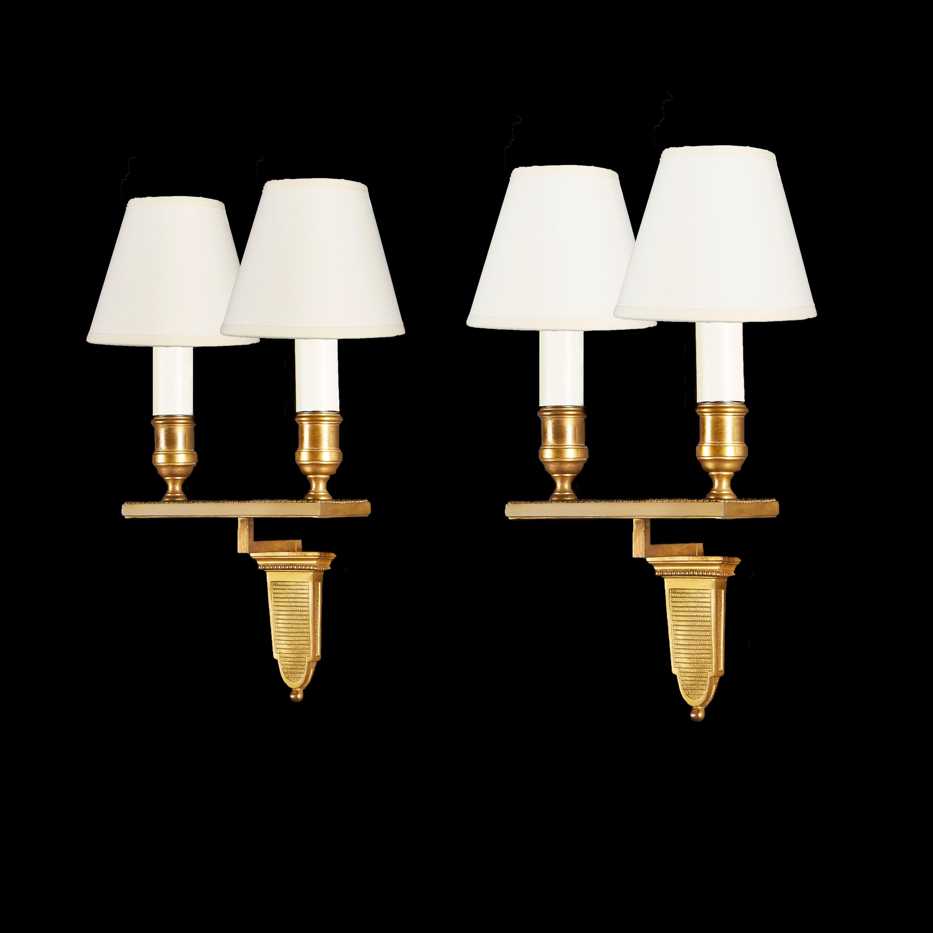 A pair of mid nineteenth century ormolu wall lights with two branches, with rectangular washboard mounts.