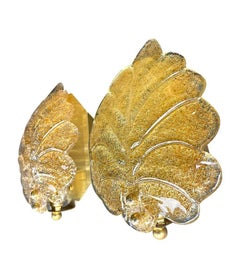 A pair of Orrefors glass and brass leaf wall sconces by Reijmyre