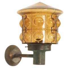 A Pair Of Outdoor Metal Wall Lamps With Glass Shades