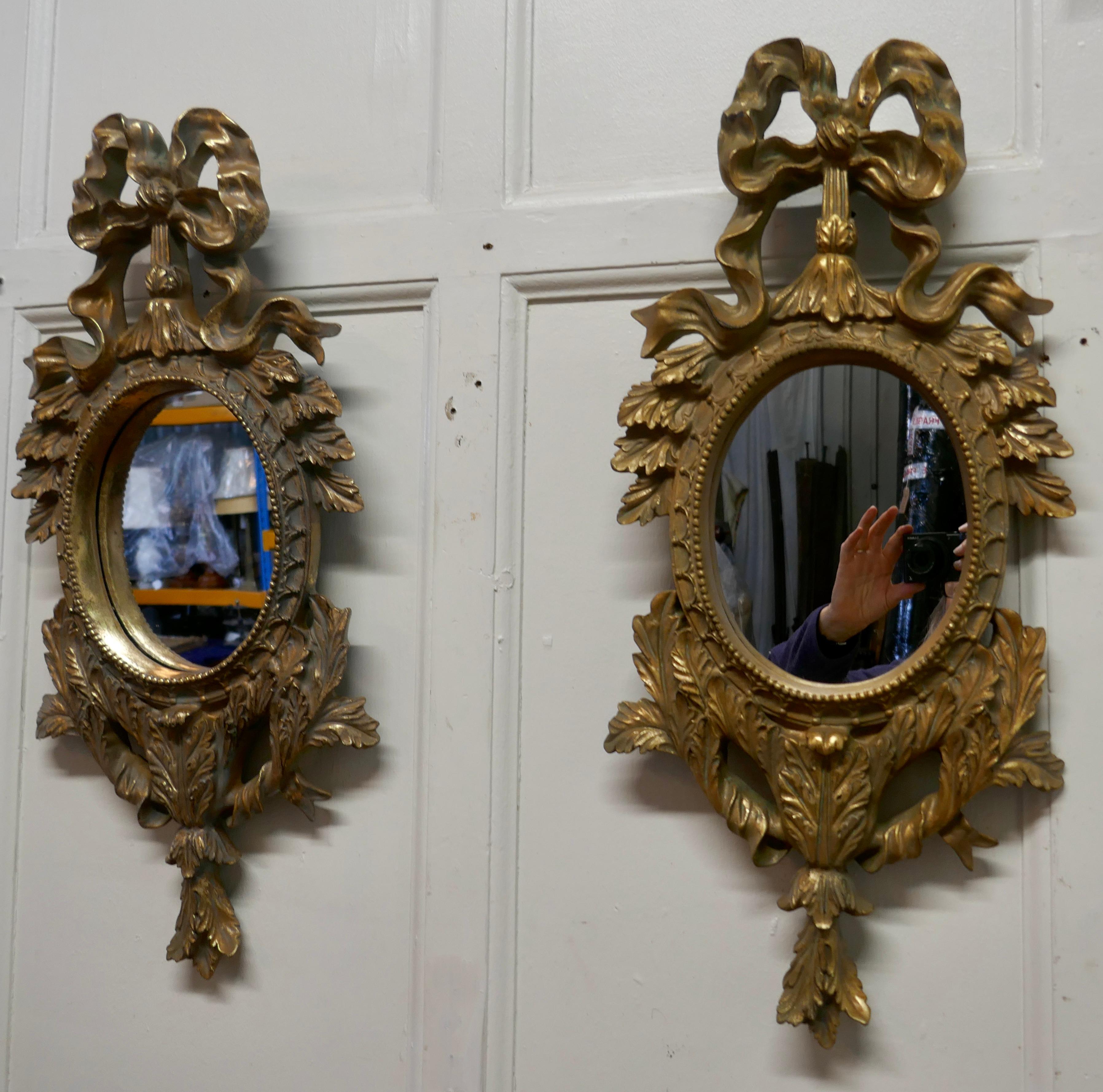 A Pair of Oval Rococo Gilt Wall Mirrors

Each of the Mirrors have an exquisite gilt Frame in the Rococo Style, they have a large Ribbon the top and abundant Acanthus leaf decoration all around 
The mirrors are 12” wide and 26” tall
WD53.