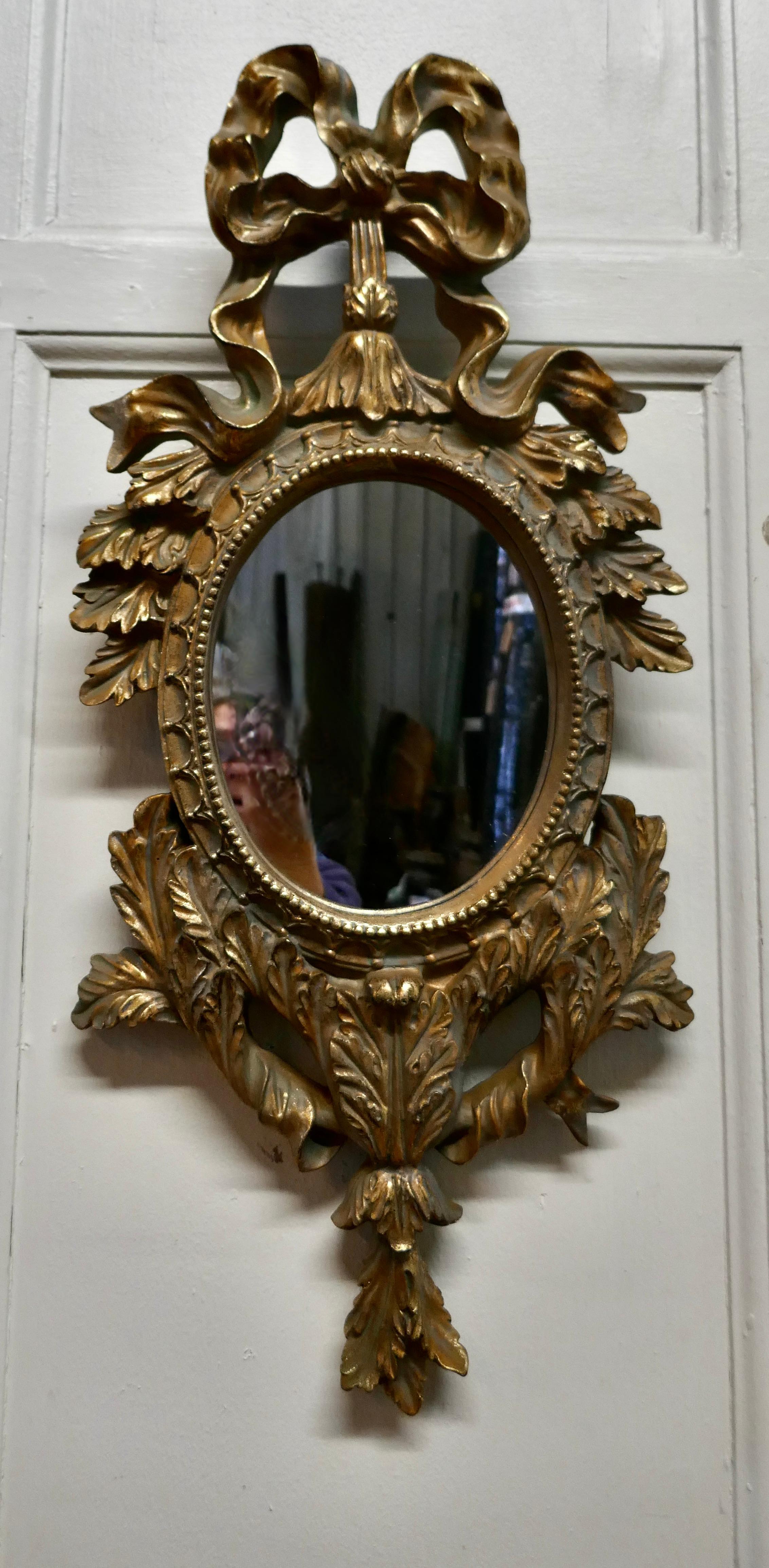 20th Century Pair of Oval Rococo Gilt Wall Mirrors For Sale