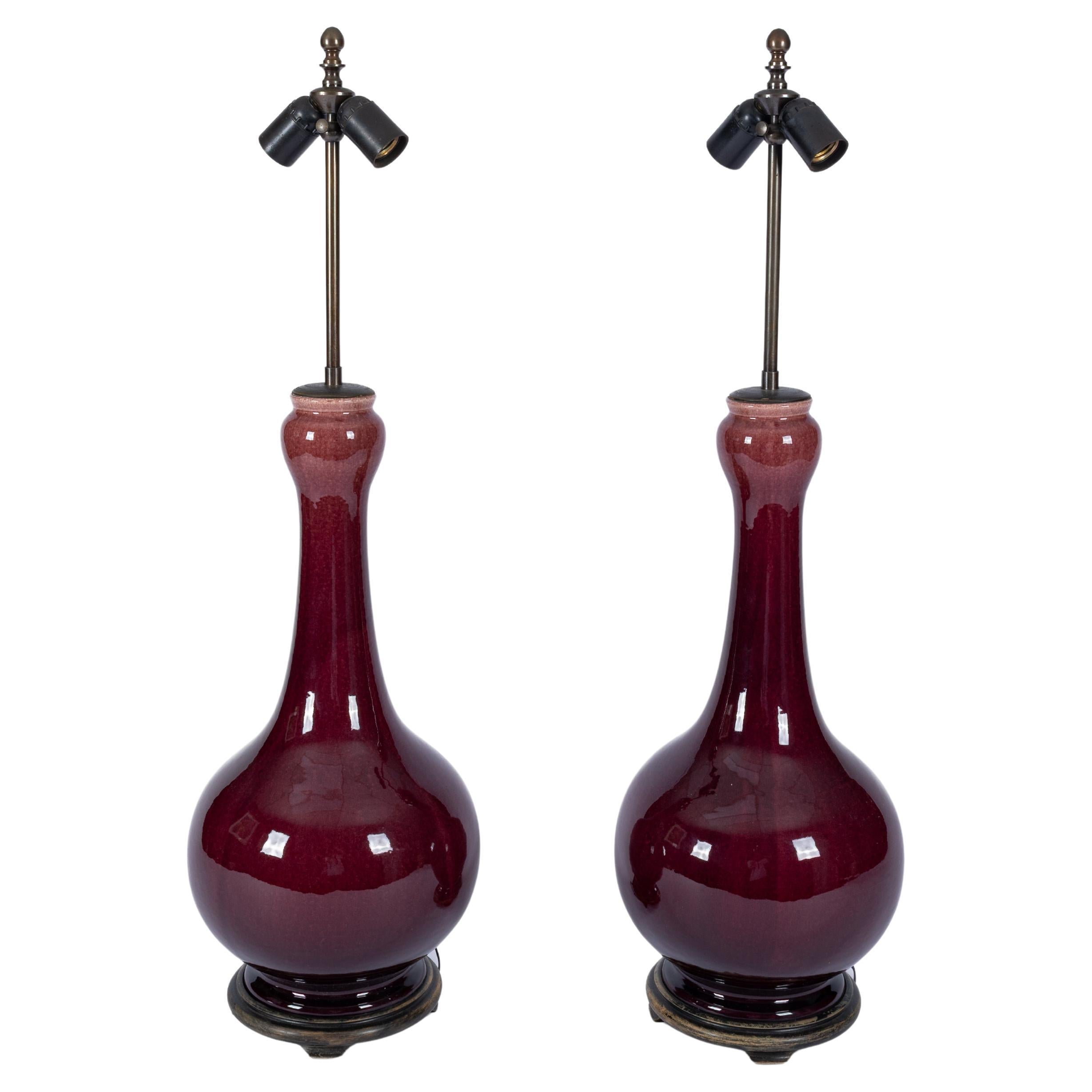 A pair of oxblood ceramic enameled table lamps