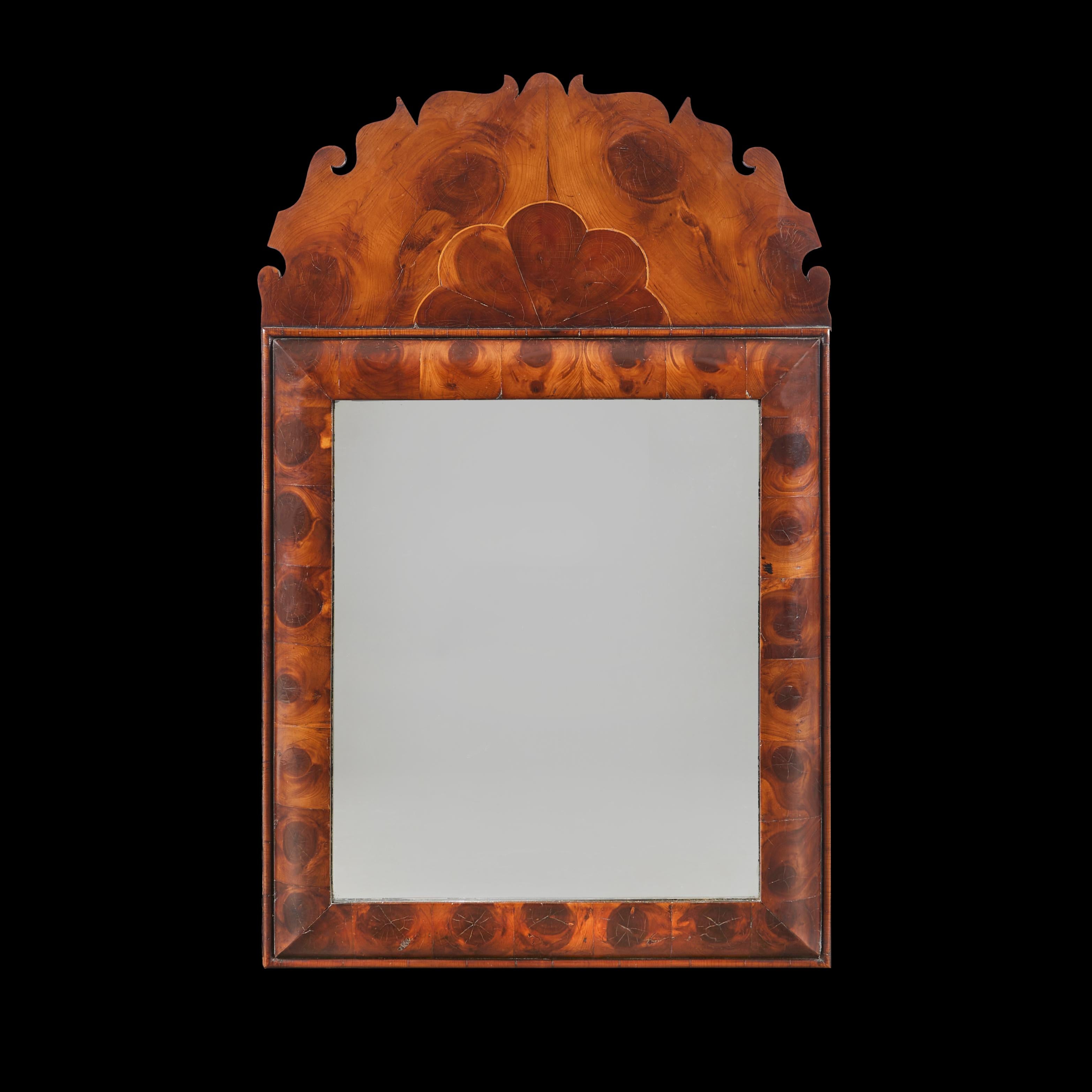 A pair of late nineteenth century cushion frame pier mirrors, with walnut oyster veneer frames, with cresting to the tops.