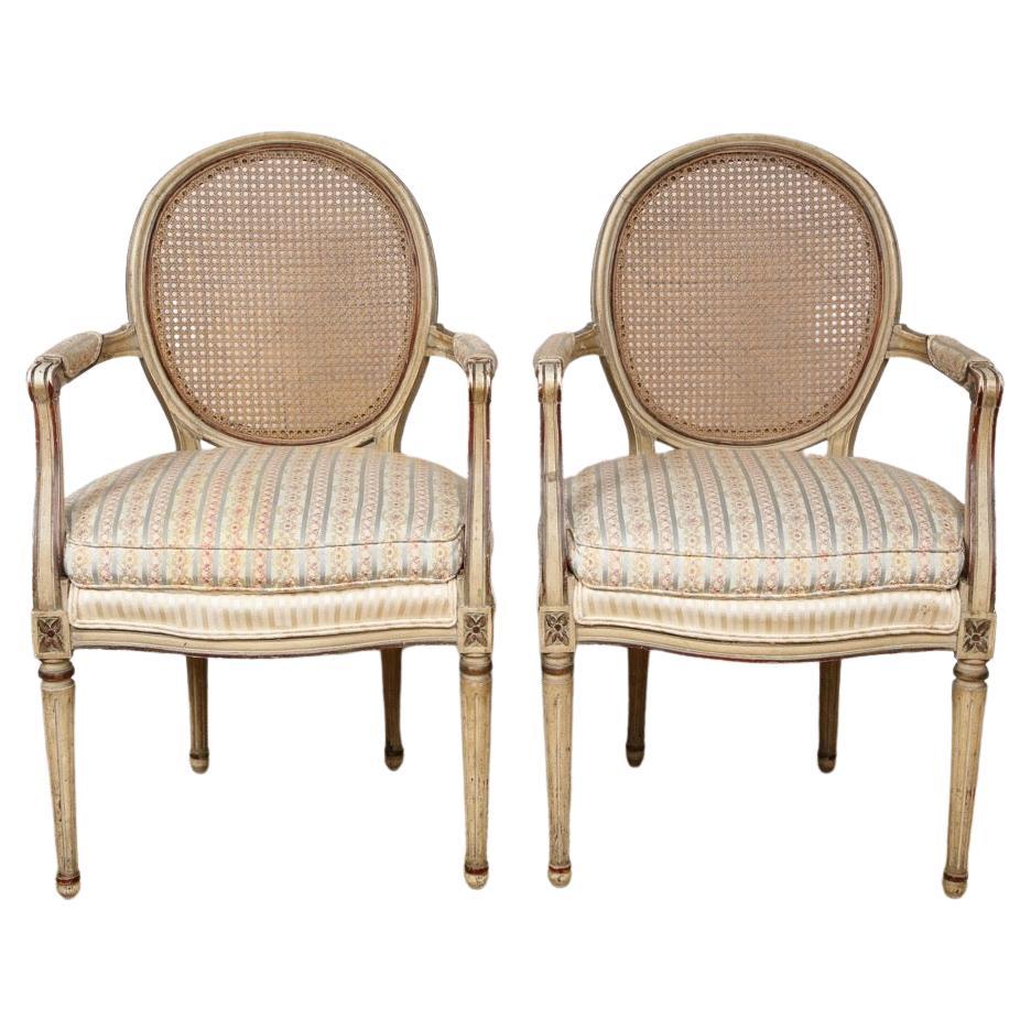 A Pair of Painted and Parcel Gilt Louis XVI Style Arm Chairs