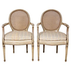 A Pair of Painted and Parcel Gilt Louis XVI Style Arm Chairs