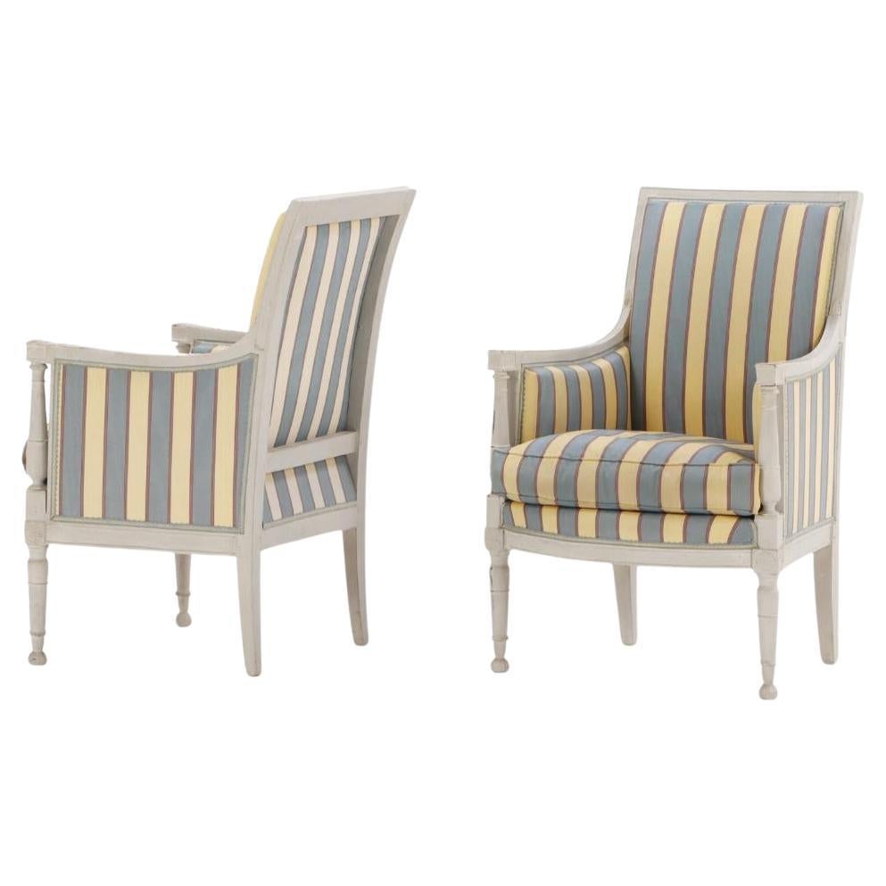 A pair of painted French Directoire style bergere chairs C 1900.