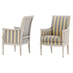 A pair of painted French Directoire style bergere chairs C 1900.