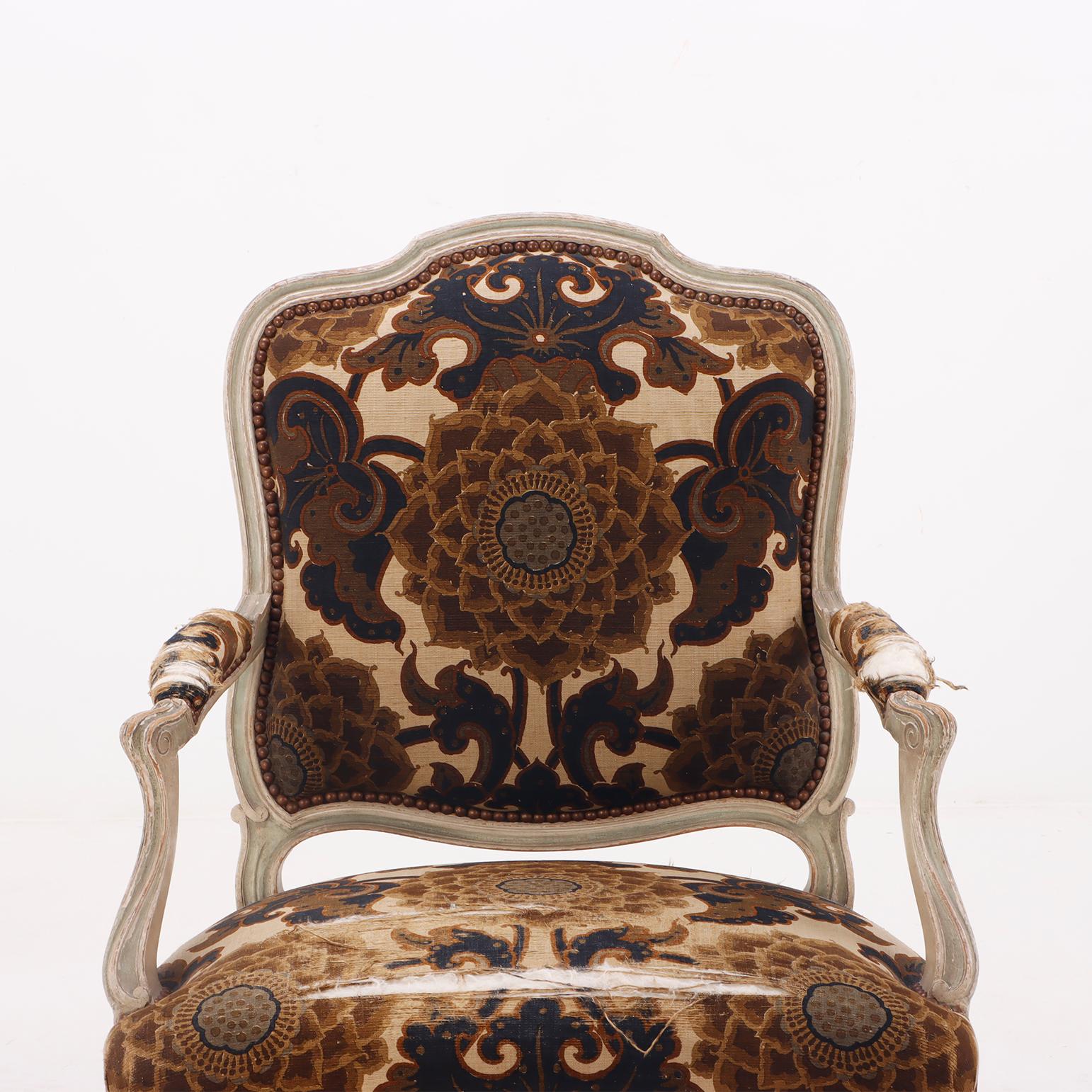 Early 20th Century A pair of painted French Louis XV style open armchairs circa 1920.