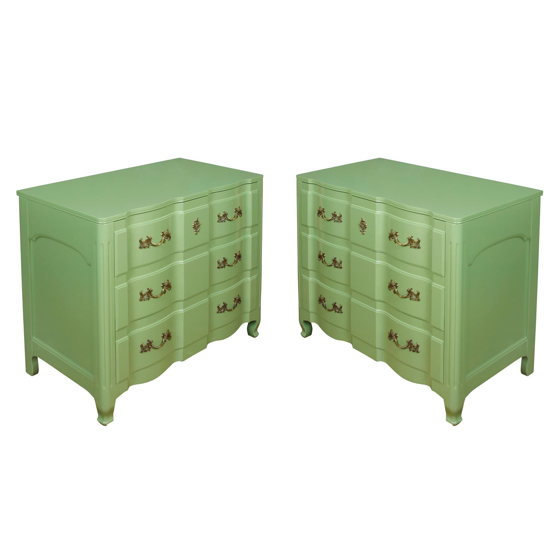 A pair of painted green, French Provincial style chests of drawers.