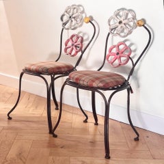 A pair of painted iron chairs by Joe Brown for Anthropologie, early aughts