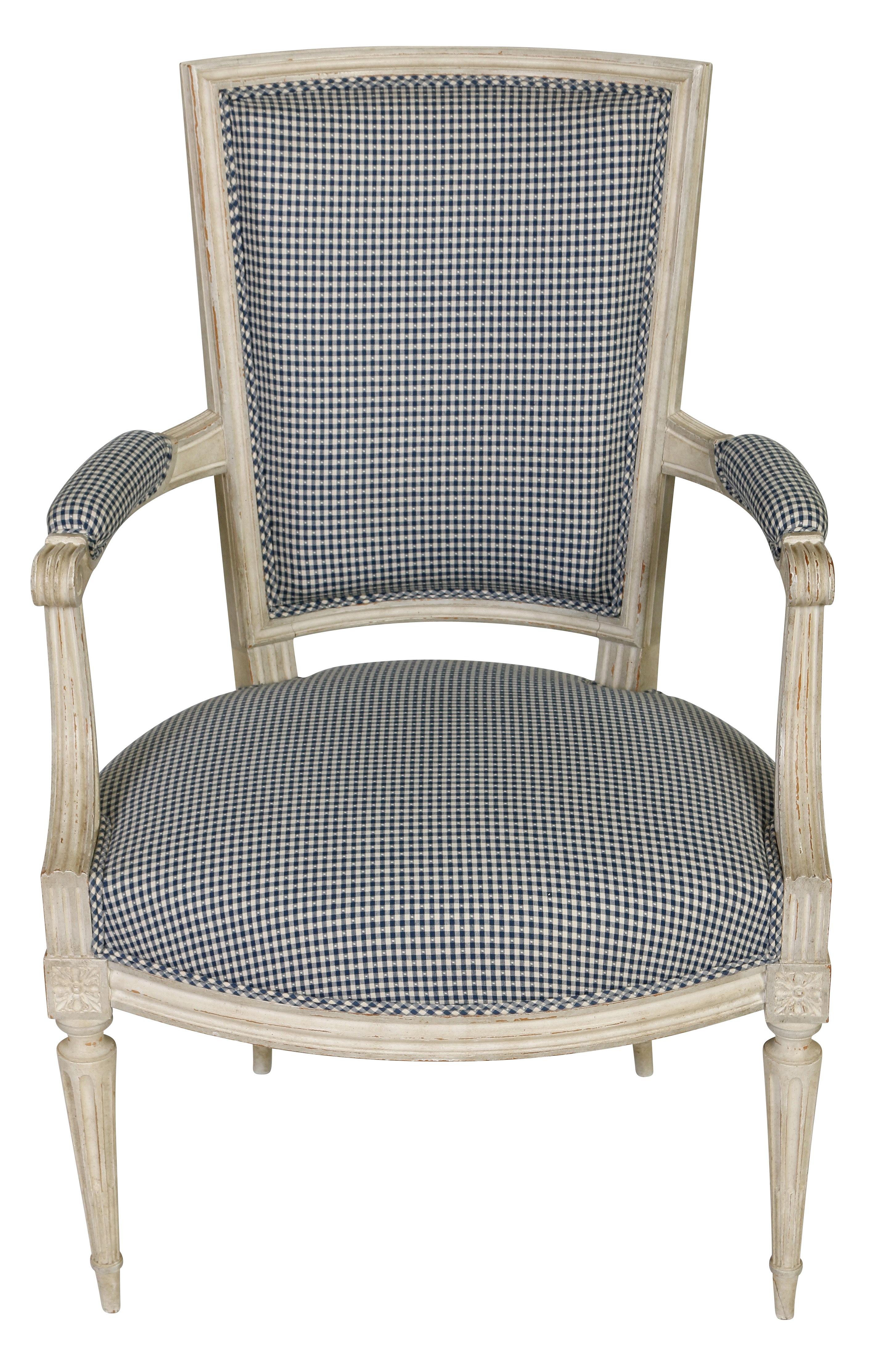 Blue and white gingham will never go out of style. This pair of arm. chairs have a grayish white painted finish. and feature many. of the lovely details characteristic of the Louis XVI style--a. squared. back, fluted, tapered legs, and beautifully