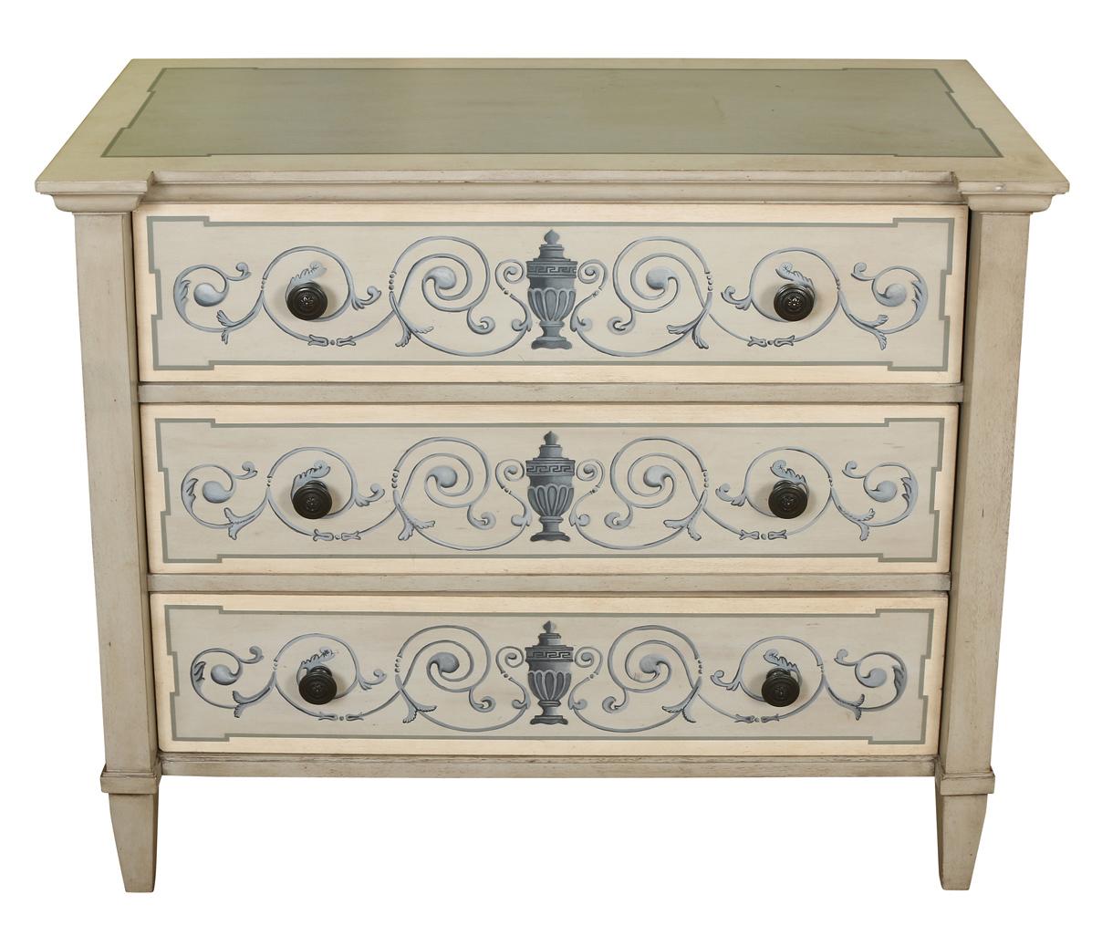 A charming chest painted in a blue gray with a neoclassical painted motif on each drawer. Each chest has three drawers and is raised on tapered feet. Priced separately at 1600 each.
