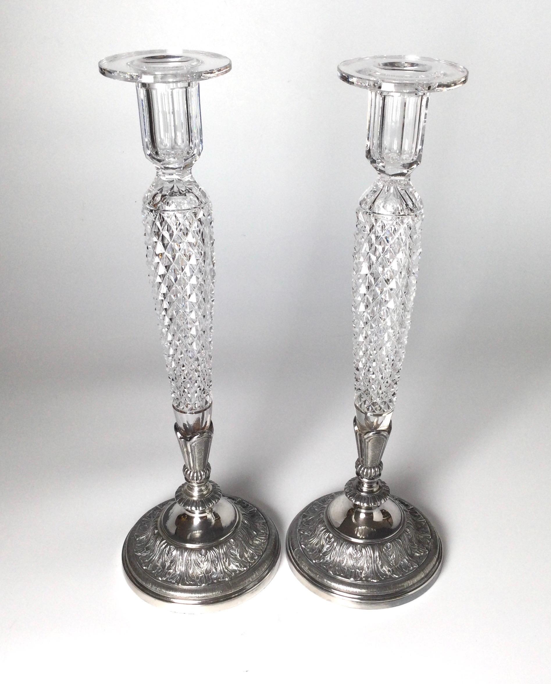 A pair of elegant tall candlesticks with a diamond cut bodies with silver-plate bases with acanthus leaf decoration, signed on the bottom Pairpoint. 16 inches tall.