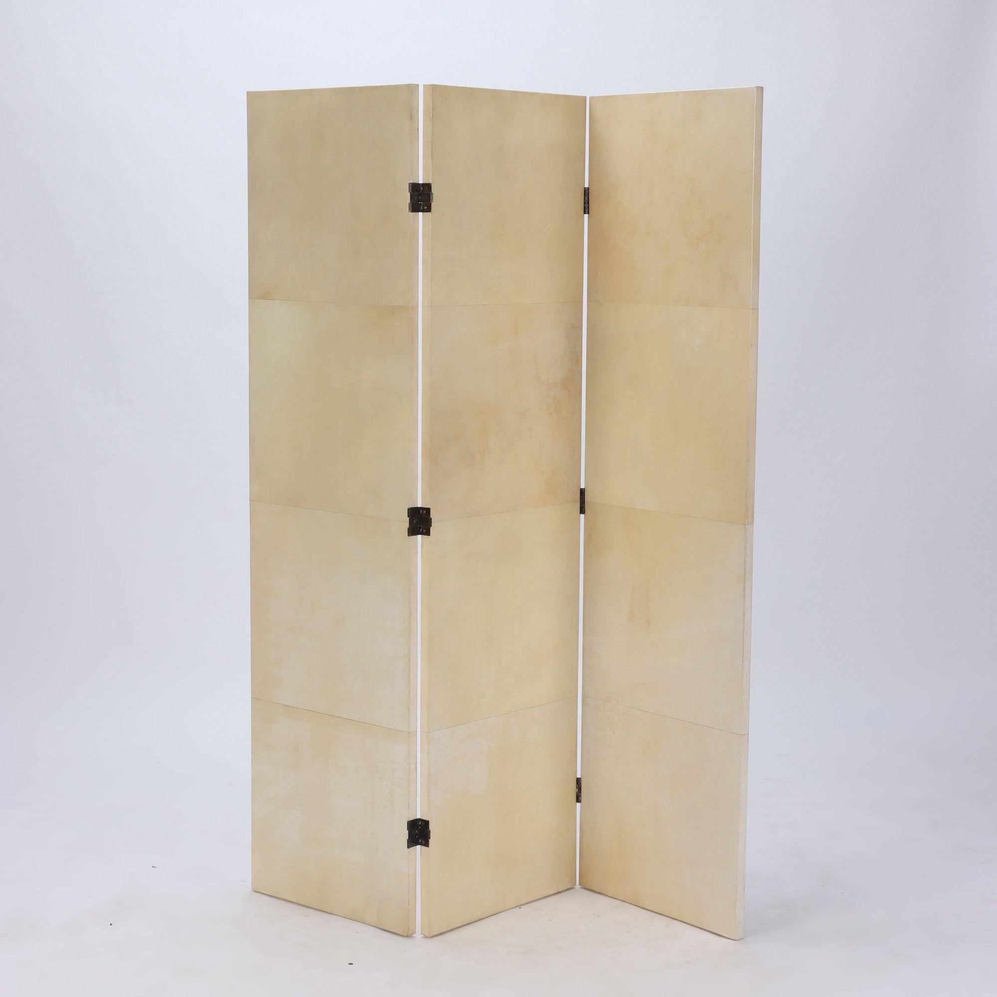 A pair of parchment covered three panel folding screens.Contemporary. Each screen is 58