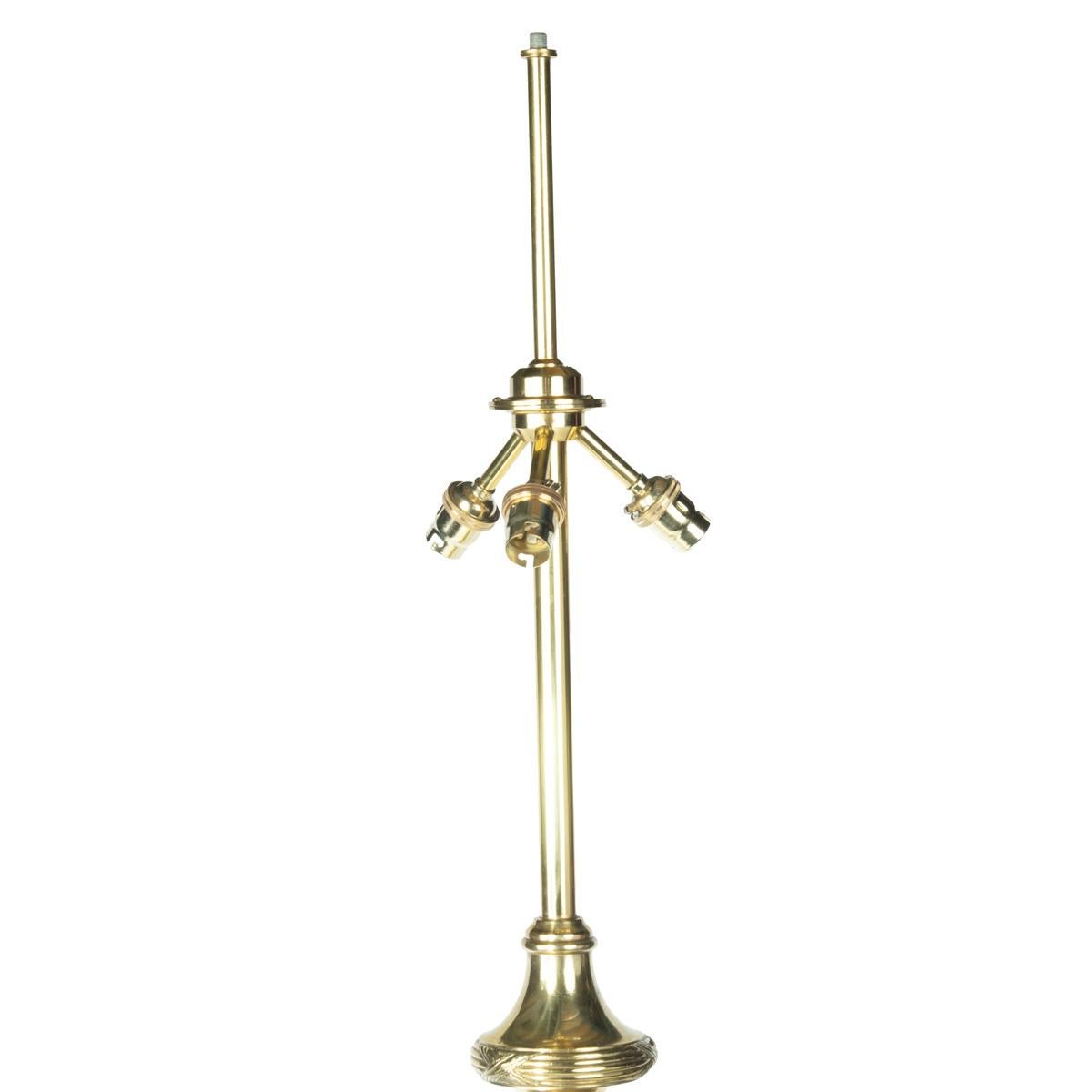 A pair of particularly fine quality French solid brass standard lamps, each with a tapering reeded support with acanthus bud end set on scrolling tripod feet.  French circa 1890.

