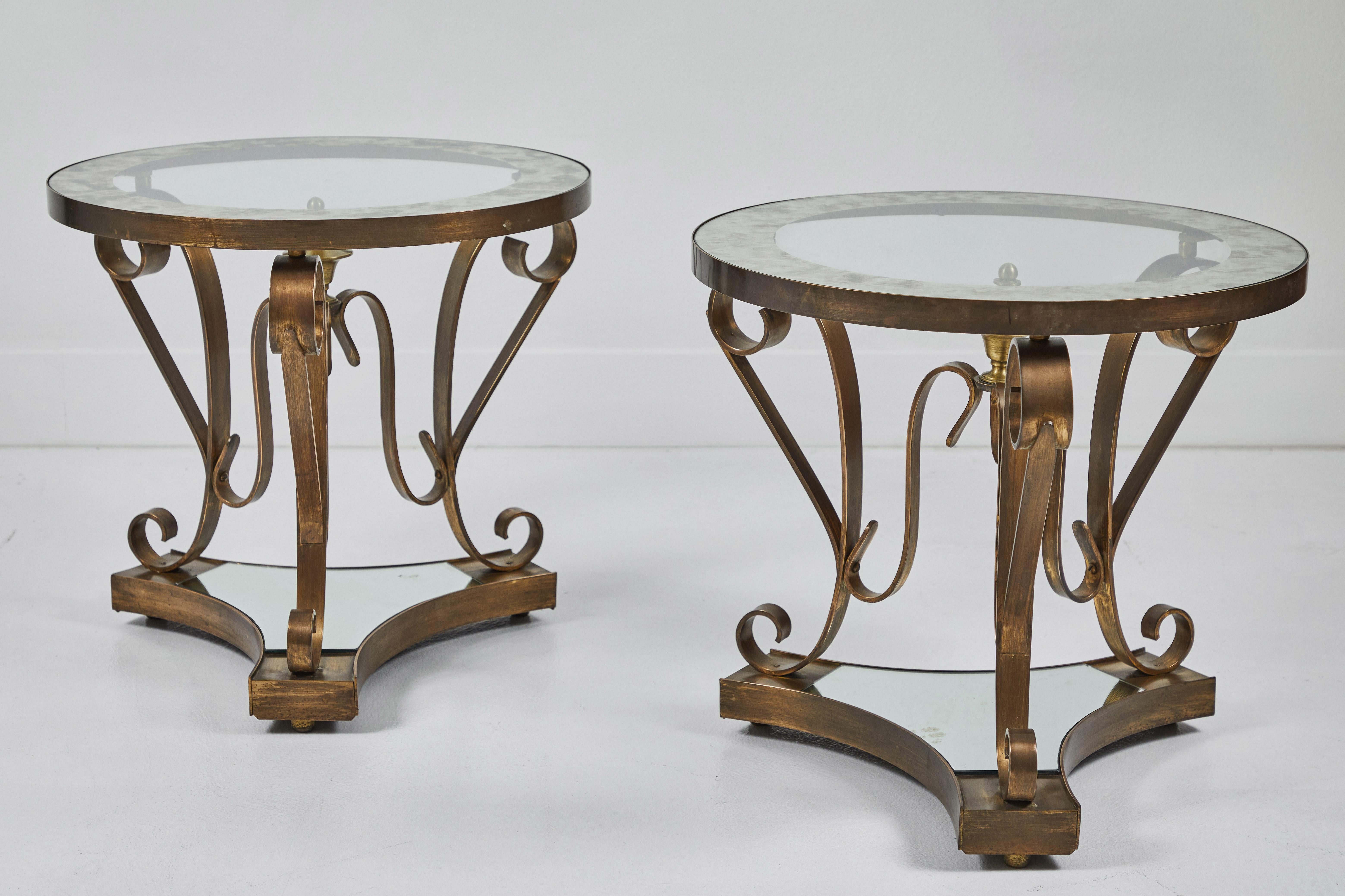 2 patinated brass and mirrored side tables by Arturo Pani (1915-1981), utilizing contrasting mediums of brass for the base, clear glass and eglimose for the top and mirror on the lower tier. These sculptural tables exemplify the Mexico City Modern