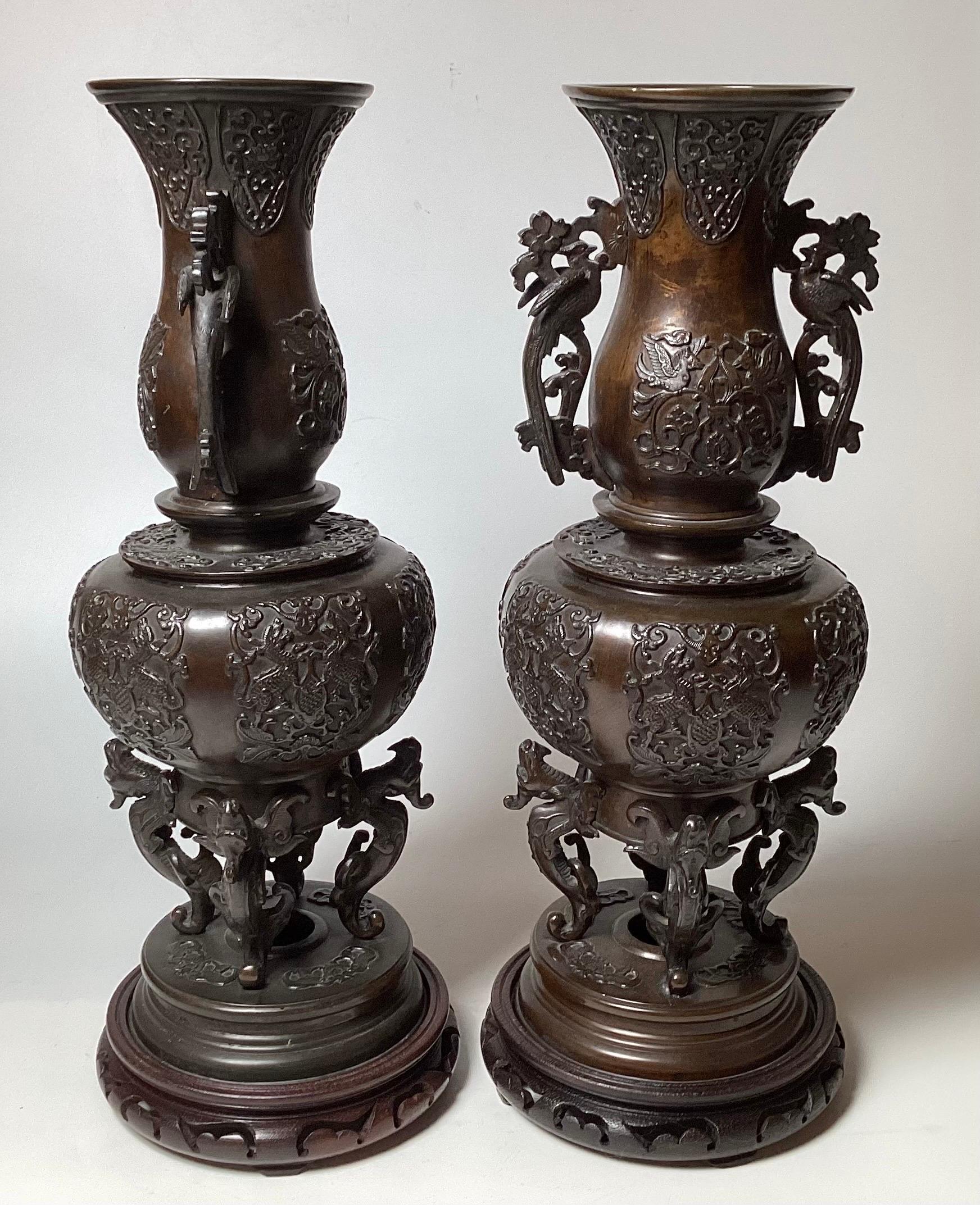 A Pair of patinated bronze figurative tall Meiji Period garniture vases, the original bark brown patination with very detailed surface and handles.  19 inches tall 