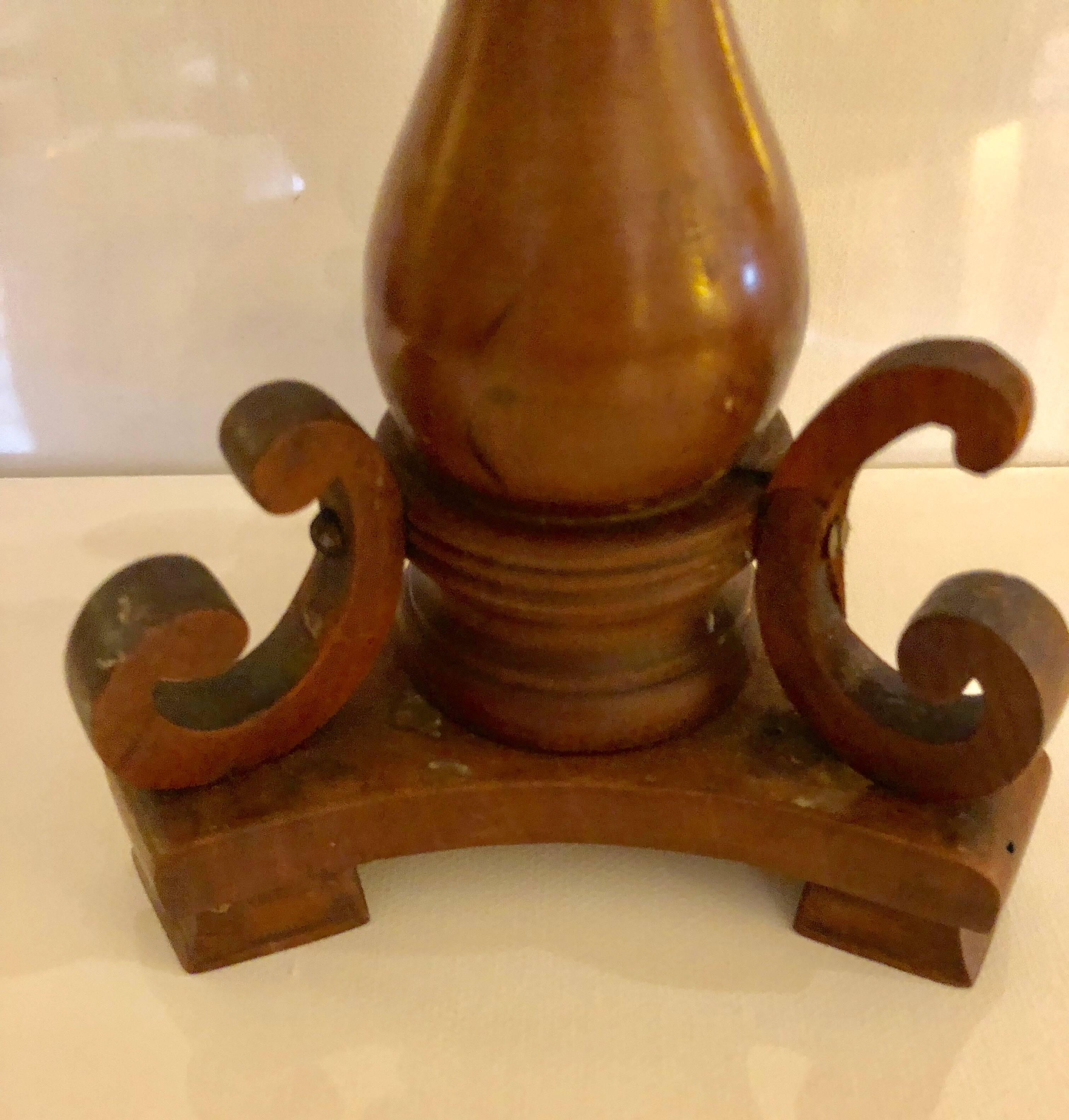 The turned baluster shaped candlesticks with C-scrolls applied to tripartite base.
