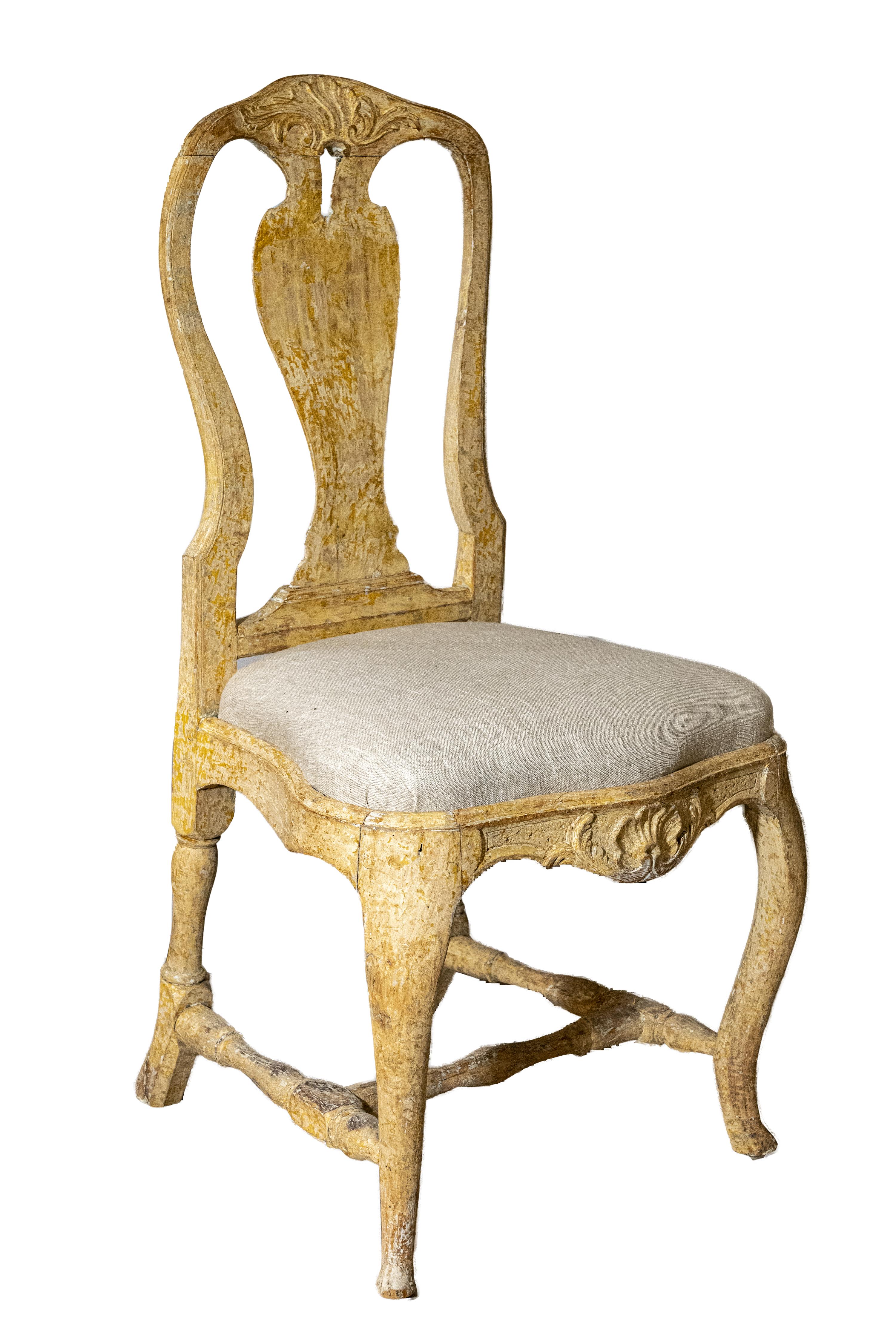 A pair of Stockholm made Rococo chairs scraped to original paint, with carved splats, cabriole legs, H-Form cross stretchers, and new linen upholstery. Created in the 18th century, each of this pair of Rococo period side chairs features a tall
