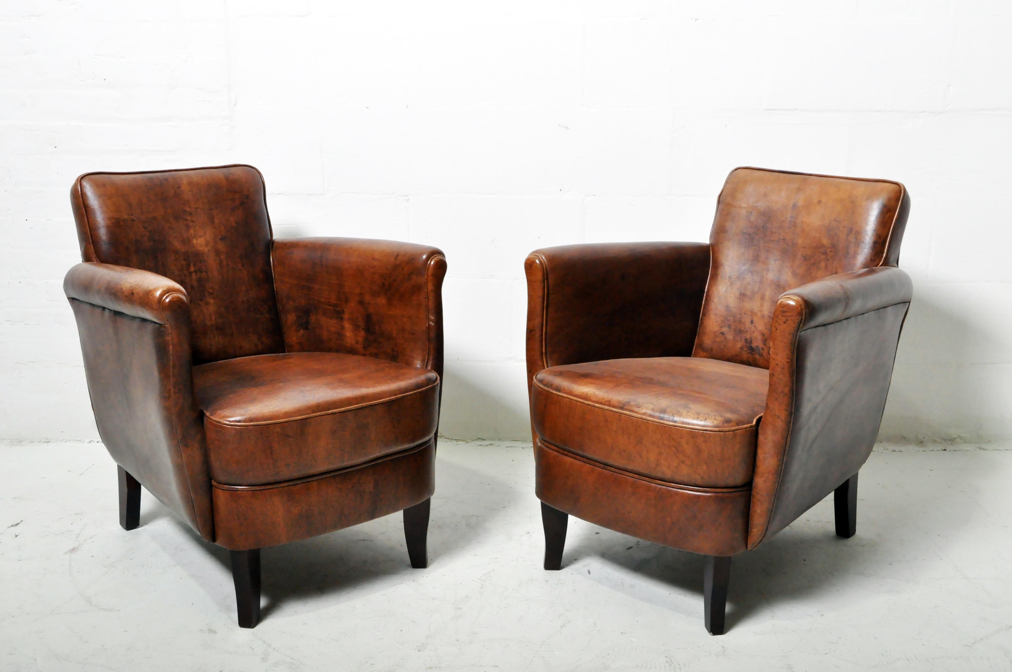 These compact leather chairs feature bold, sheep leather, thick padded seats and slim, roll panel arms.