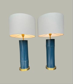 A pair of petrol blue lacquered bamboo and brass lamps