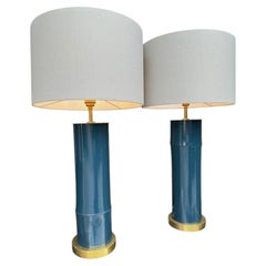 A pair of petrol blue lacquered bamboo and brass lamps