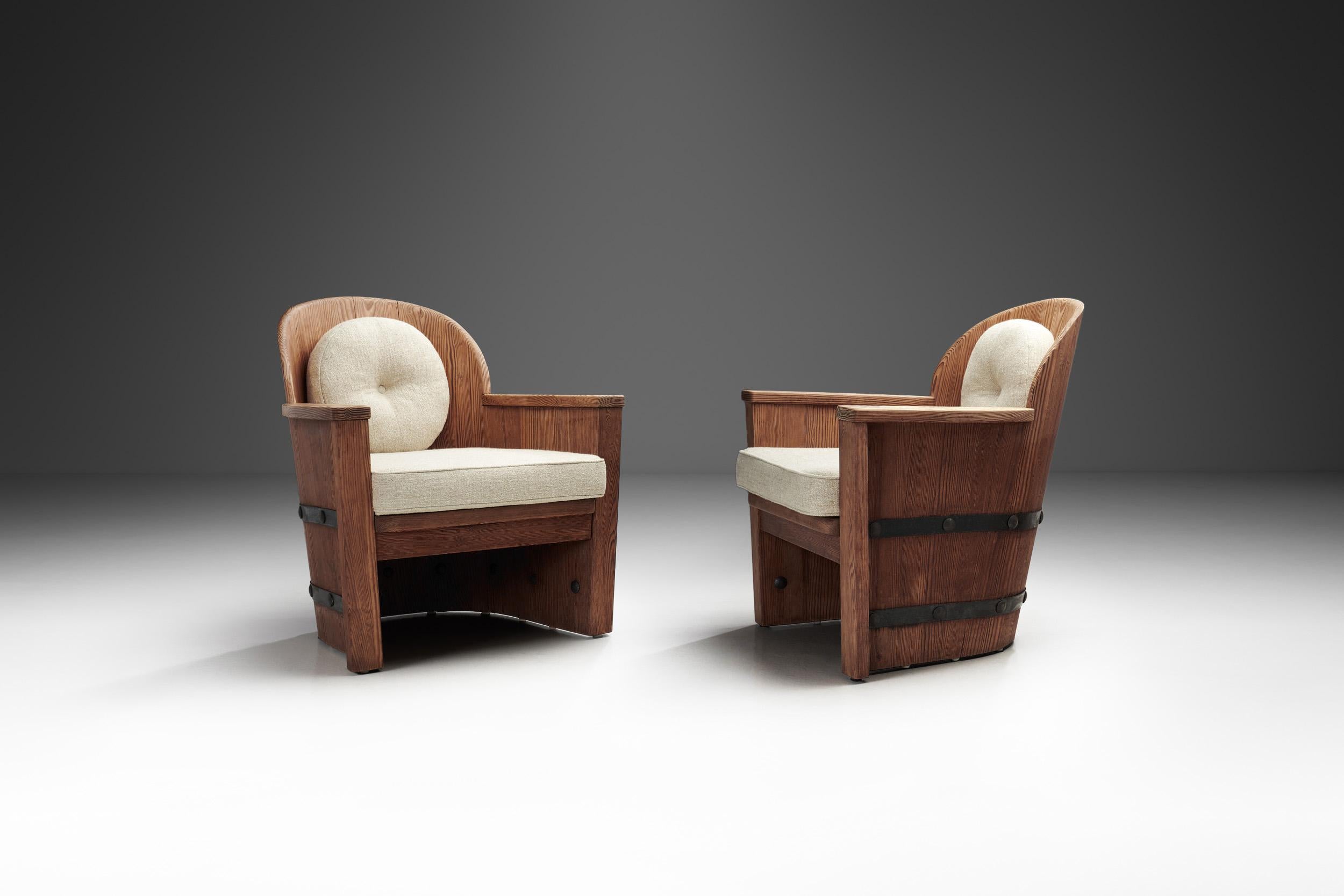 This pair is a striking example of mid-century Scandinavian design, blending natural materials with industrial elements. The chairs feature a robust frame constructed from solid pine, which is known for its durability and warm, organic tones. The