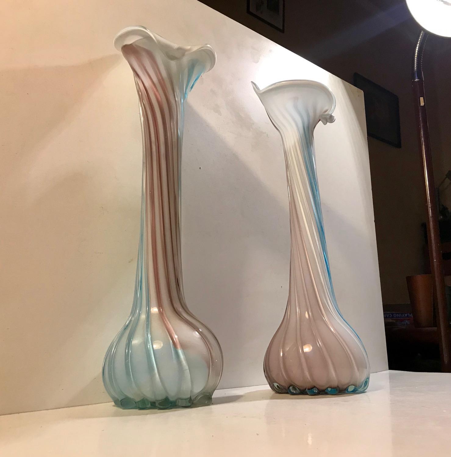 A pair of 'Jack in the Pulpit' vases in cased and twisted Murano glass. Anonymous glass studio/designer in Murano or Venezia circa 1940-1950 in the style of Loetz Rainbow series. The vases are mouth blown and display variances in color composition.