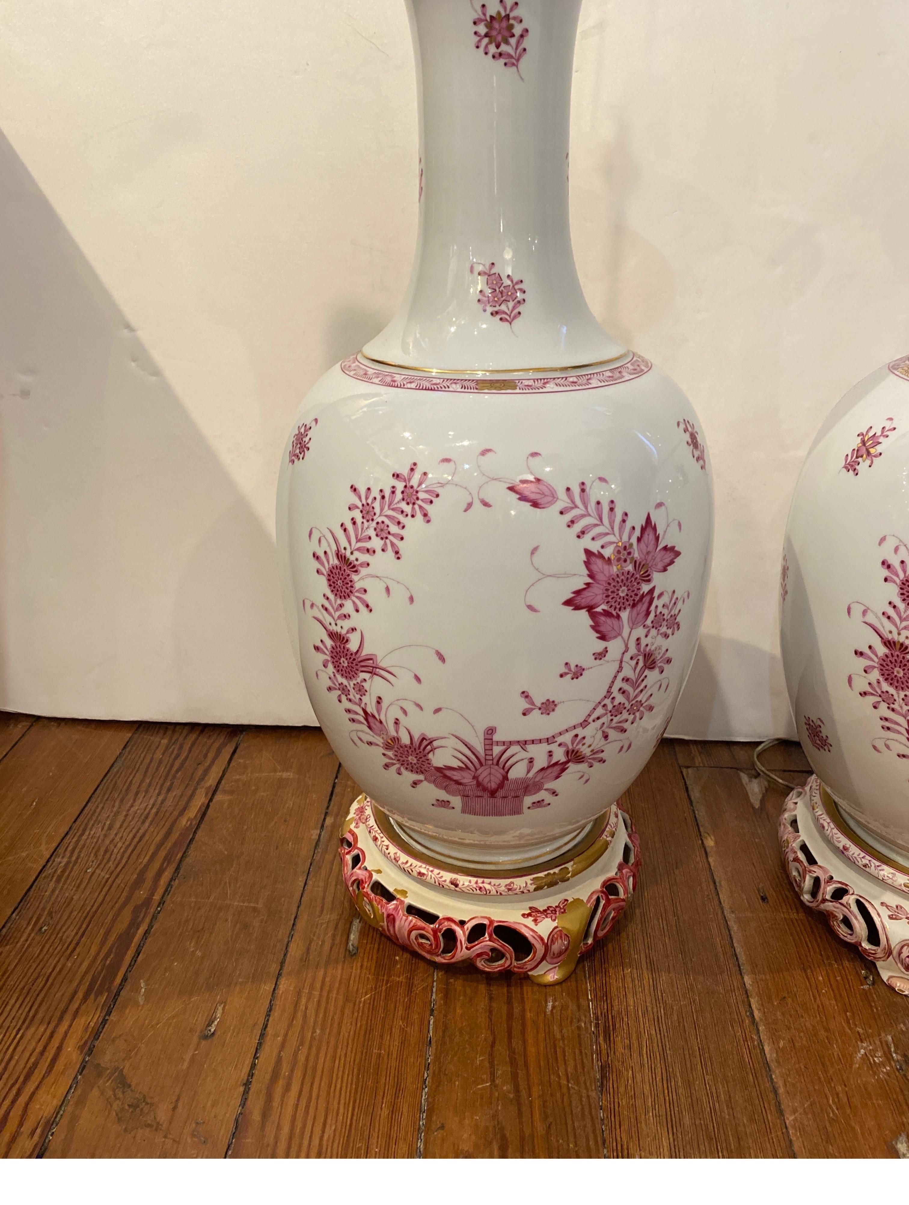 Beautiful hand painted Herand porcelain lamps with hand painted bases. The bulbous white porcelain lamps with hand painted floral decoration all over, the bases were custom made with some minor flaking to just the bases. Marked with a faint blue