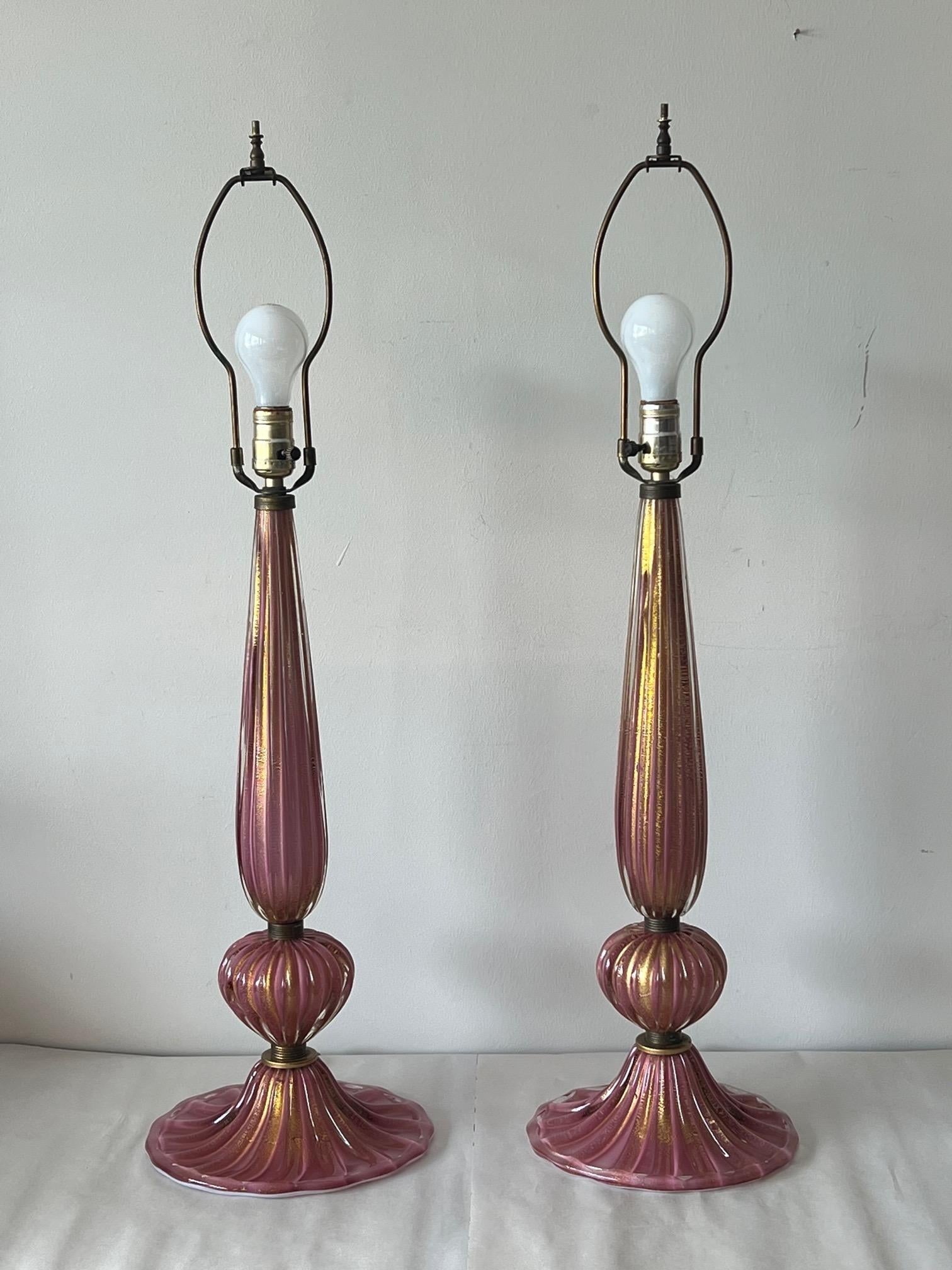 A pair of beautiful and rare to find Murano glass, pink/lavender table lamps with gold flecks. Ca' 1950s, most likely by Barovier, with original harps/wiring-from the original owners. The lamps are approx. 9