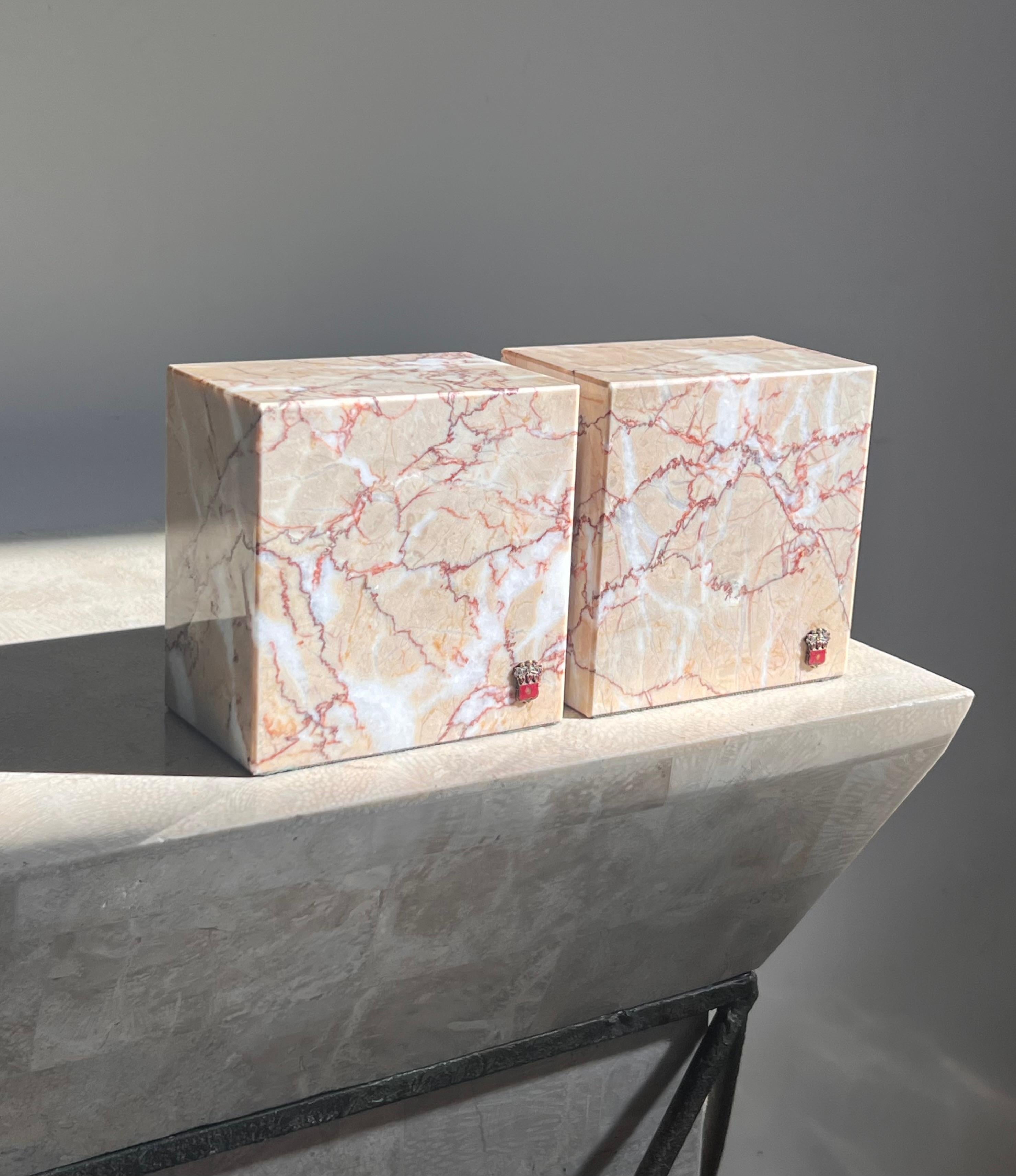 A pair of pink marble bookends by Vermont Marble Co, mid 20th century. Pale pink with burgundy and brilliant coral veining. Felted bottoms. Note the Vermont Marble Company insignia is intact on each bookend. Very heavy and in wonderful condition.